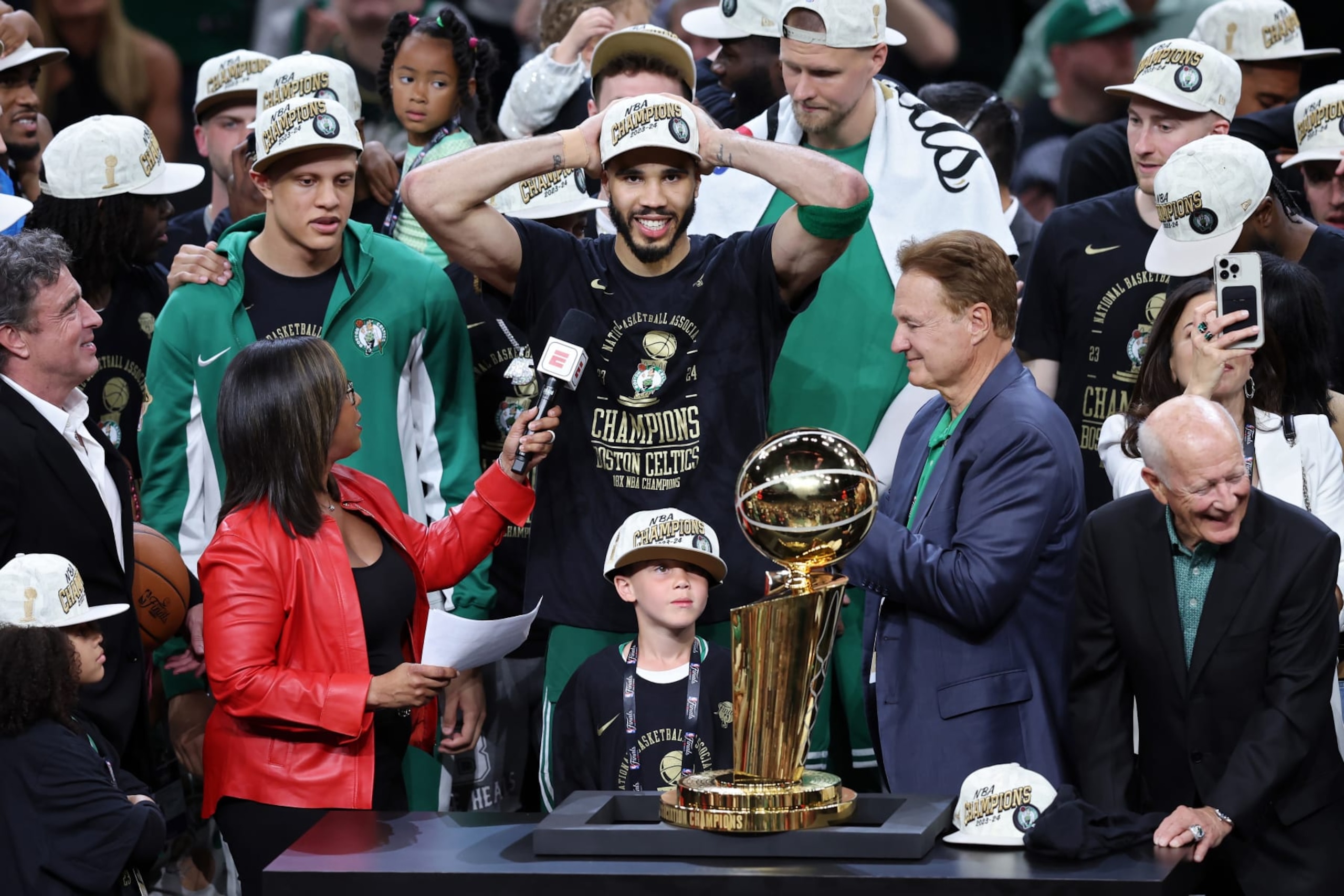 BOSTON, MASSACHUSETTS - JUNE 17: Jayson Tatum #0 of the Boston Celtics celebrates in front of the Larry O’Brien Championship Trophy after Boston's 106-88 win against the Dallas Mavericks in Game Five of the 2024 NBA Finals at TD Garden on June 17, 2024 in Boston, Massachusetts. NOTE TO USER: User expressly acknowledges and agrees that, by downloading and or using this photograph, User is consenting to the terms and conditions of the Getty Images License Agreement. (Photo by Adam Glanzman/Getty Images)