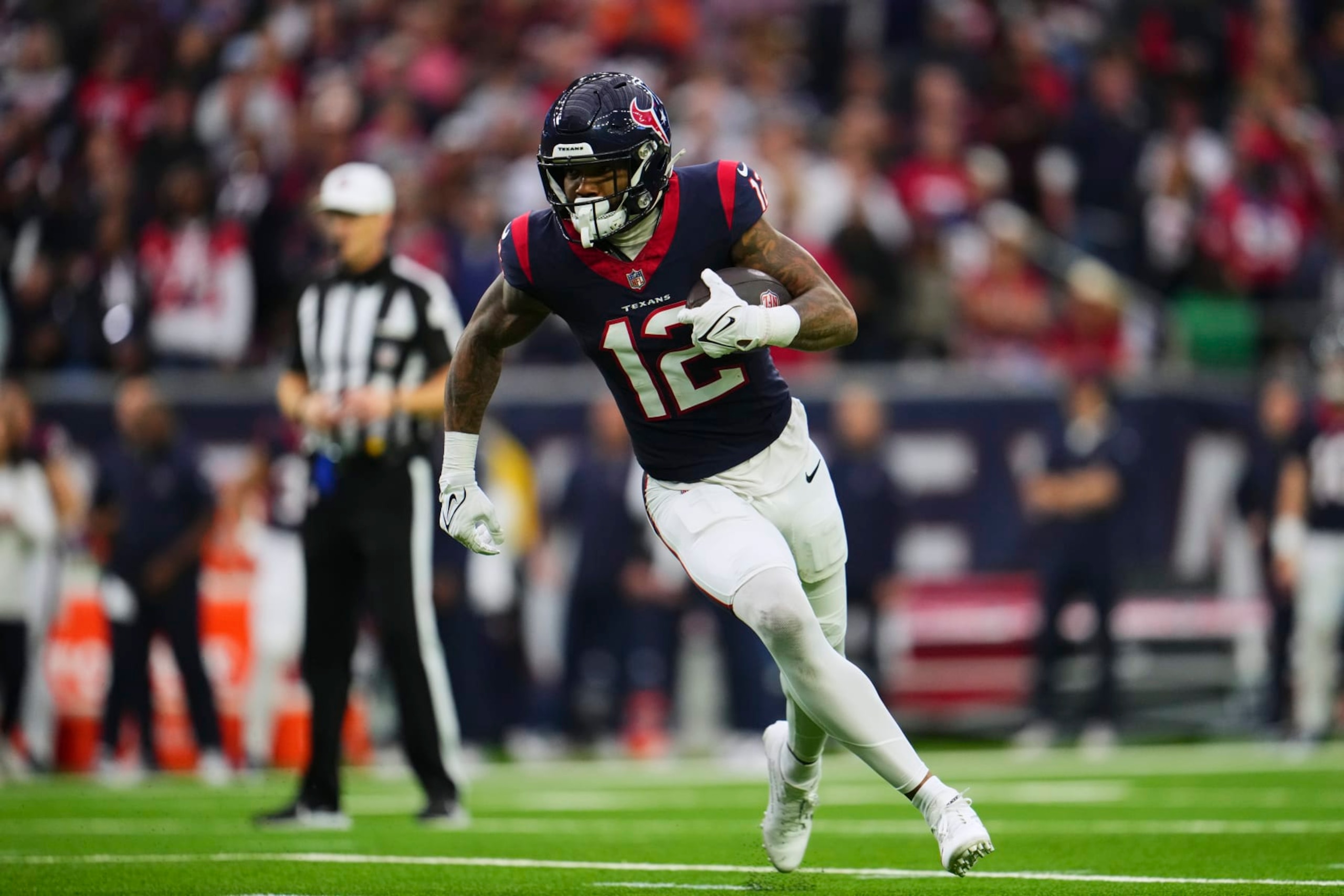 HOUSTON, TX - JANUARY 13: Nico Collins #12 of the Houston Texans runs with the ball against the Cleveland Browns during the first half of the AFC Wild Card playoff game at NRG Stadium on January 13, 2024 in Houston, Texas. (Photo by Cooper Neill/Getty Images) HOUSTON, TX - JANUARY 13: Nico Collins #12 of the Houston Texans runs with the ball against the Cleveland Browns during the first half of the AFC Wild Card playoff game at NRG Stadium on January 13, 2024 in Houston, Texas. (Photo by Cooper Neill/Getty Images)