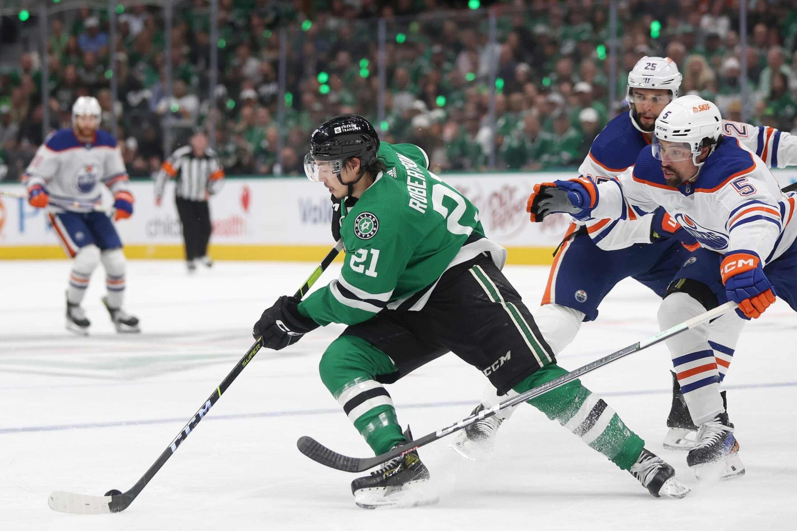 DALLAS, TEXAS - MAY 31: Jason Robertson #21 of the Dallas Stars advances the puck against Cody Ceci #5 of the Edmonton Oilers in the first period during Game Five of the Western Conference Final of the 2024 Stanley Cup Playoffs at American Airlines Center on May 31, 2024 in Dallas, Texas. (Photo by Matthew Stockman/Getty Images)