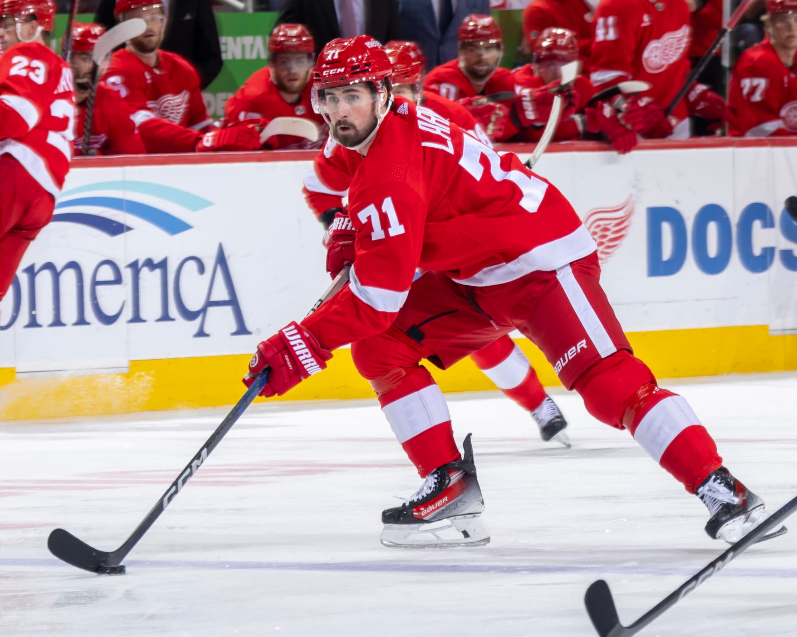 DETROIT, MI - APRIL 09: Dylan Larkin #71 of the Detroit Red Wings skates up ice with the puck against the Washington Capitals during the first period at Little Caesars Arena on April 9, 2024 in Detroit, Michigan. Washington defeated Detroit 2-1. (Photo by Dave Reginek/NHLI via Getty Images)