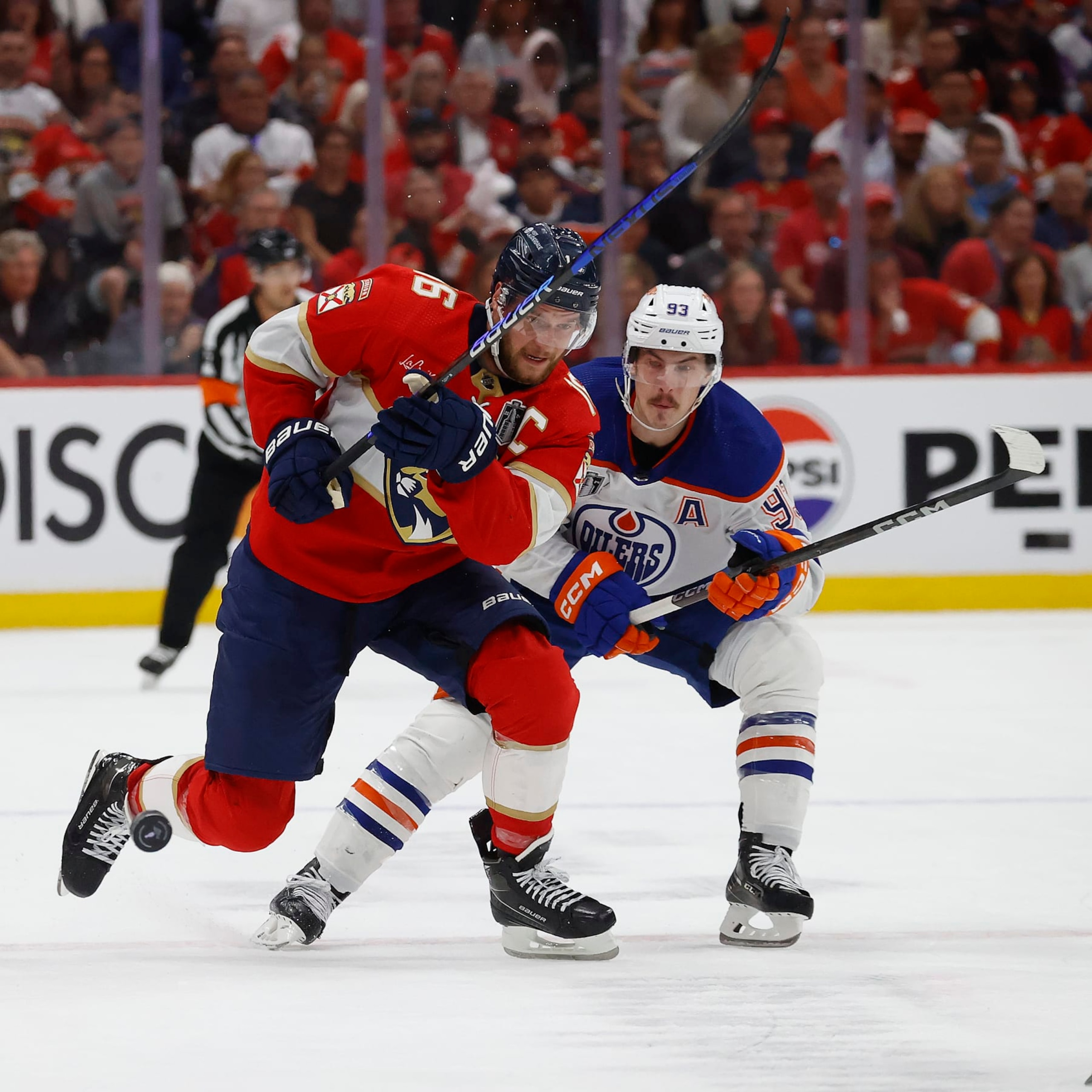 SUNRISE, FLORIDA - JUNE 10: Aleksander Barkov #16 of the Florida Panthers skates for possession against Ryan Nugent-Hopkins #93 of the Edmonton Oilers in Game Two of the Stanley Cup Final at the Amerant Bank Arena on June 10, 2024 in Sunrise, Florida. (Photo by Eliot J. Schechter/NHLI via Getty Images)