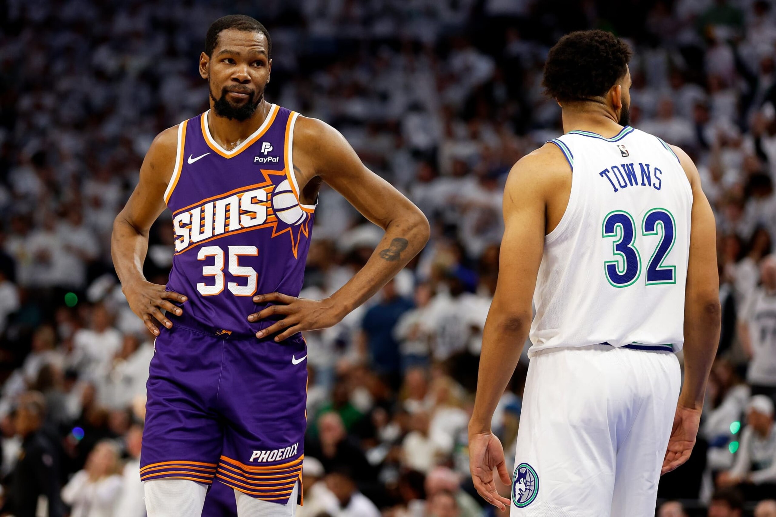 MINNEAPOLIS, MINNESOTA - APRIL 23: Kevin Durant #35 of the Phoenix Suns and Karl-Anthony Towns #32 of the Minnesota Timberwolves look on in the fourth quarter of game two of the Western Conference First Round Playoffs at Target Center on April 23, 2024 in Minneapolis, Minnesota. The Timberwolves defeated the Sun 105-93. NOTE TO USER: User expressly acknowledges and agrees that, by downloading and or using this photograph, User is consenting to the terms and conditions of the Getty Images License Agreement. (Photo by David Berding/Getty Images)