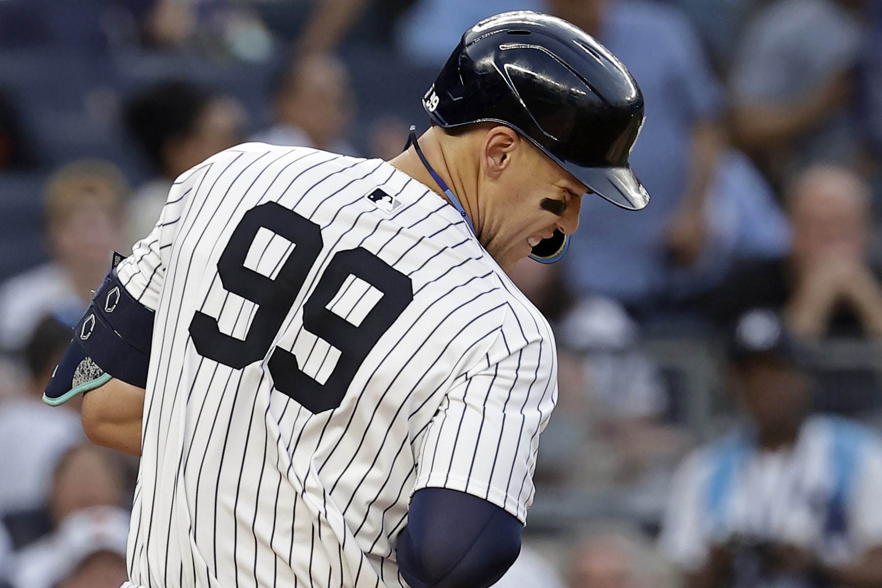 NEW YORK, NY - JUNE 18: Aaron Judge #99 of the New York Yankees reacts after being hit by a pitch by the Baltimore Orioles during the third inning at Yankee Stadium on June 18, 2024 in New York City. (Photo by Adam Hunger/Getty Images)
