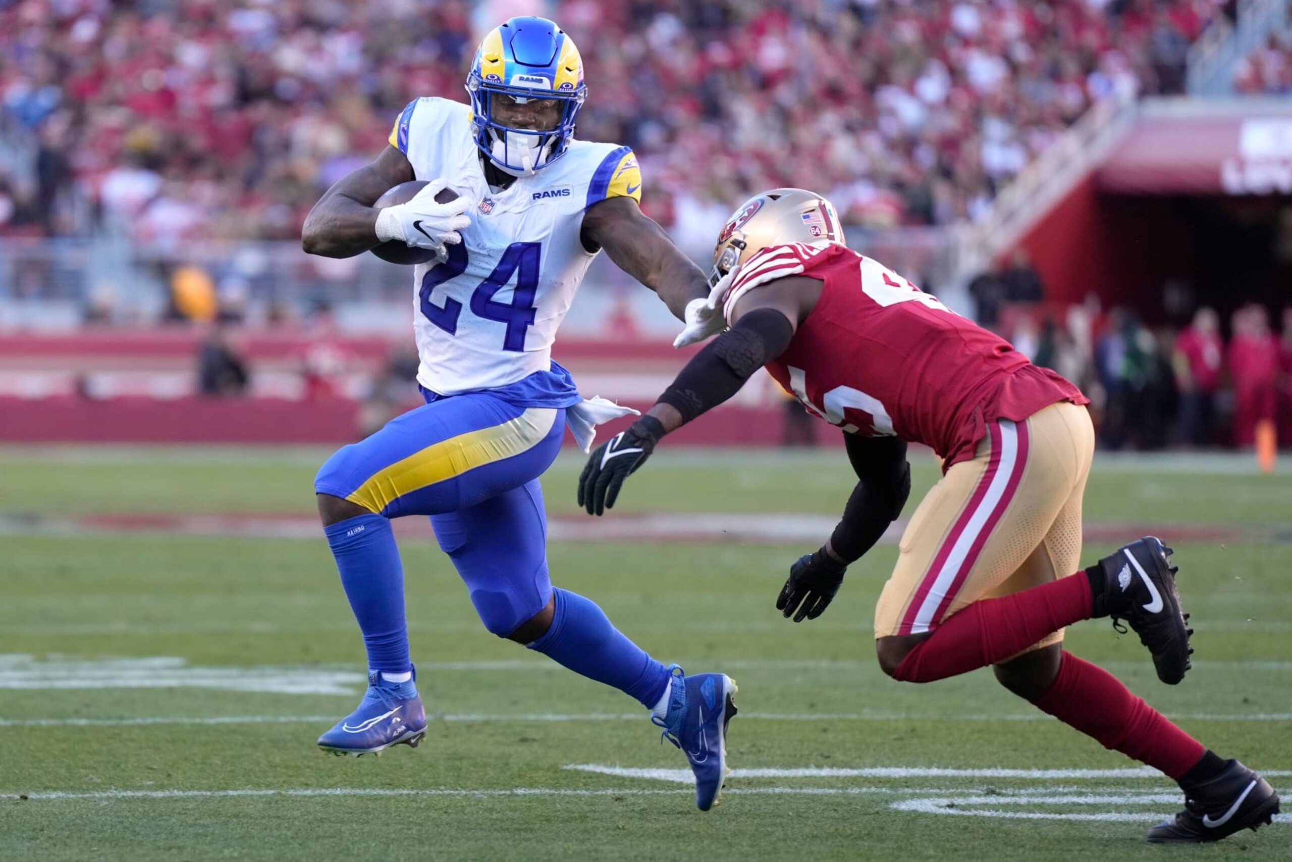 SANTA CLARA, CALIFORNIA - JANUARY 07: Royce Freeman #24 of the Los Angeles Rams stiff arms Demetrius Flannigan-Fowles #45 of the San Francisco 49ers in the third quarter during a game at Levi's Stadium on January 07, 2024 in Santa Clara, California. (Photo by Thearon W. Henderson/Getty Images)