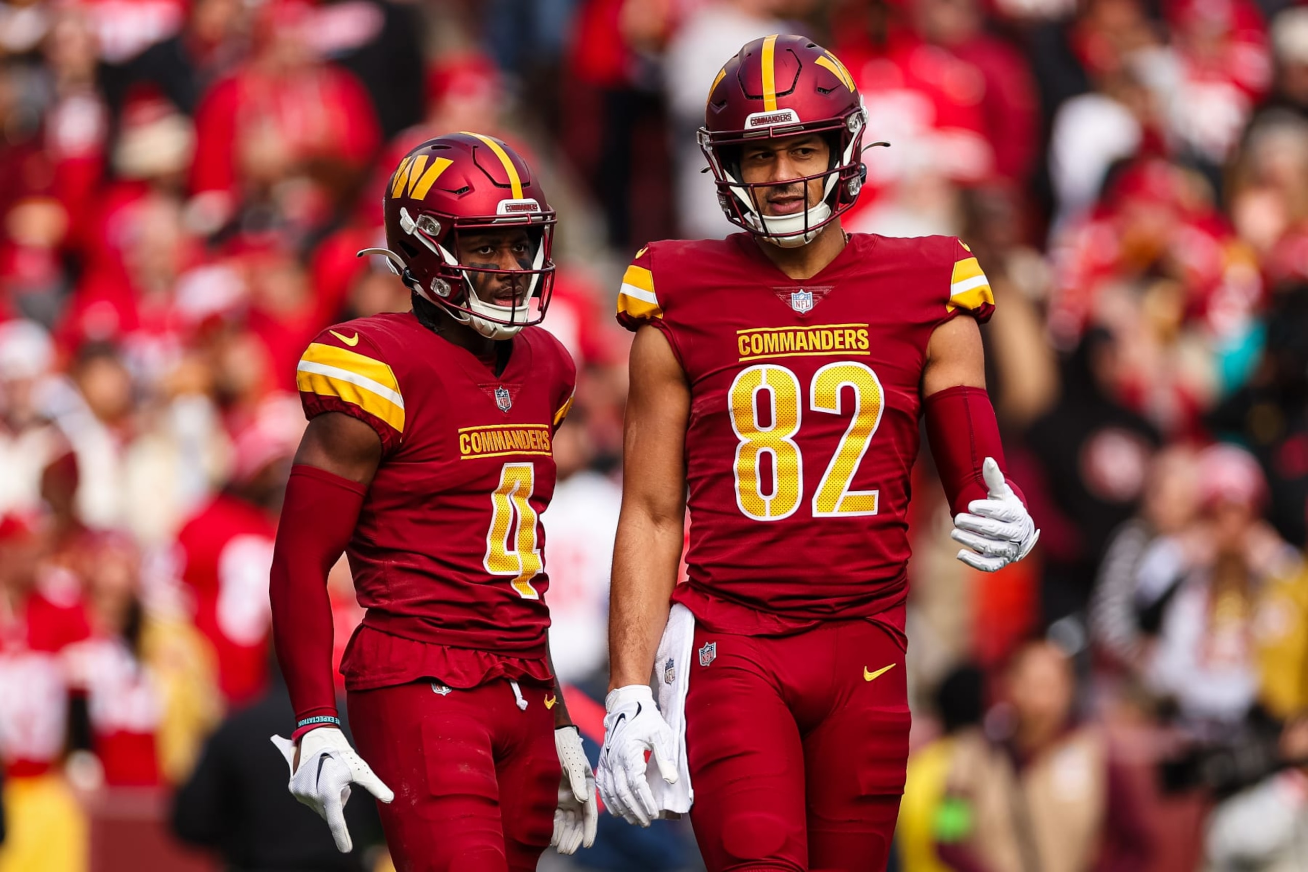 LANDOVER, MD - DECEMBER 31: Curtis Samuel #4 and Logan Thomas #82 of the Washington Commanders interact during the first half of the game against the San Francisco 49ers at FedExField on December 31, 2023 in Landover, Maryland. (Photo by Scott Taetsch/Getty Images)