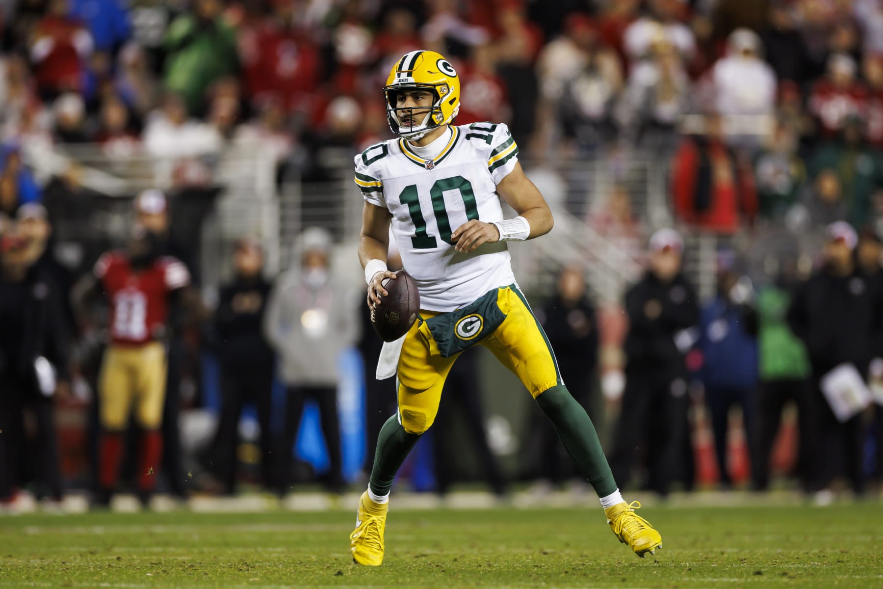 SANTA CLARA, CALIFORNIA - JANUARY 20: Jordan Love #10 of the Green Bay Packers rolls out and looks to throw a pass during an NFC divisional round playoff football game against the San Francisco 49ers at Levi's Stadium on January 20, 2024 in Santa Clara, California. (Photo by Ryan Kang/Getty Images)