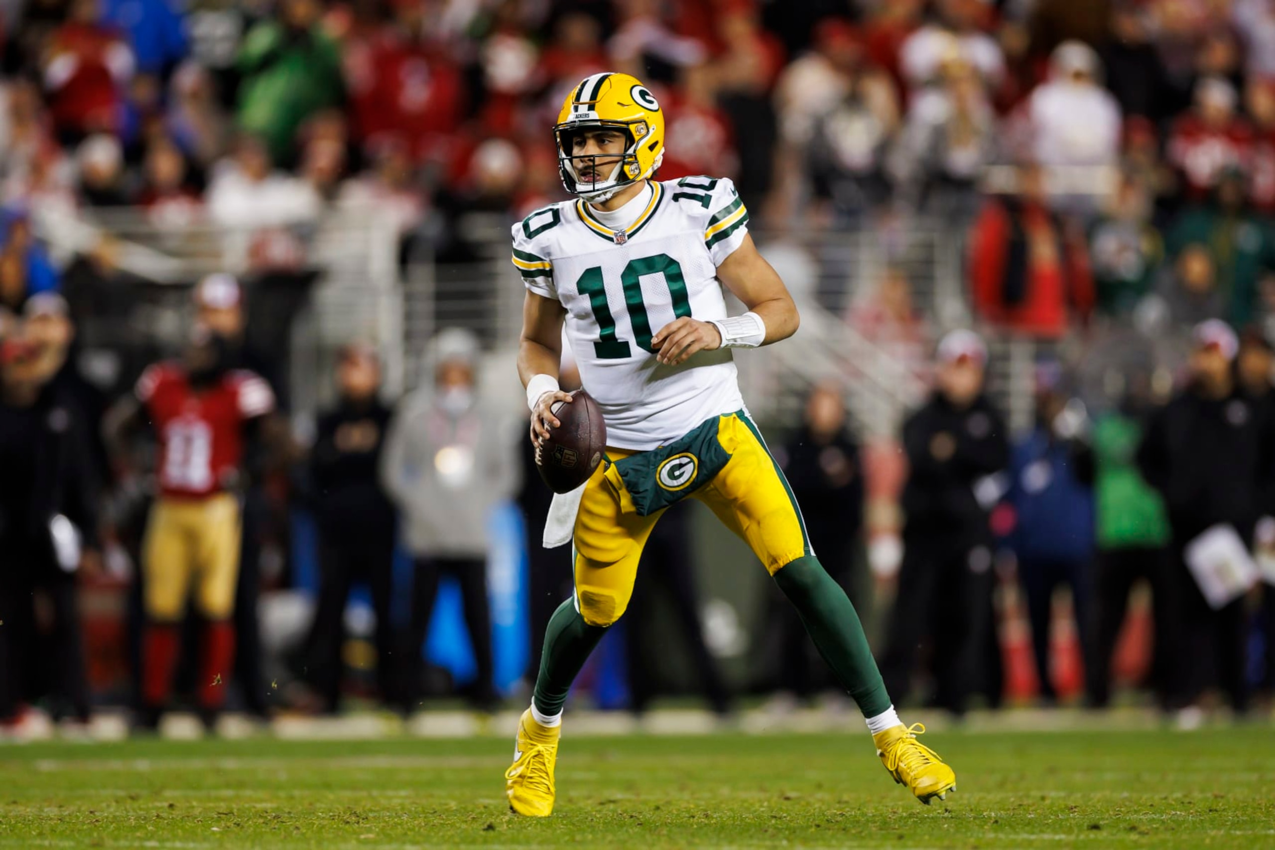 SANTA CLARA, CALIFORNIA - JANUARY 20: Jordan Love #10 of the Green Bay Packers rolls out and looks to throw a pass during an NFC divisional round playoff football game against the San Francisco 49ers at Levi's Stadium on January 20, 2024 in Santa Clara, California. (Photo by Ryan Kang/Getty Images)