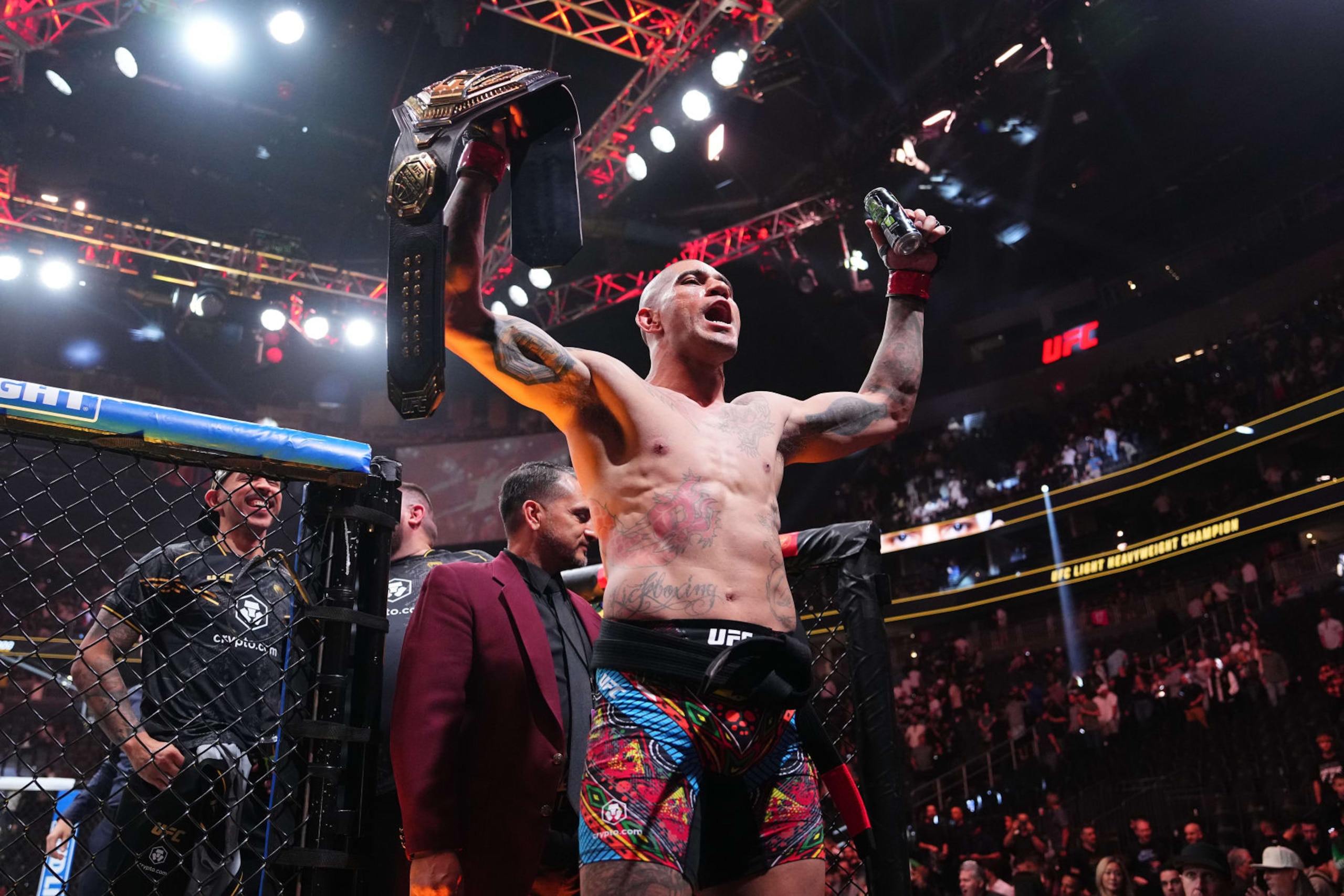 Alex Pereira hoists the UFC light heavyweight title after knocking out Jamahal Hill.