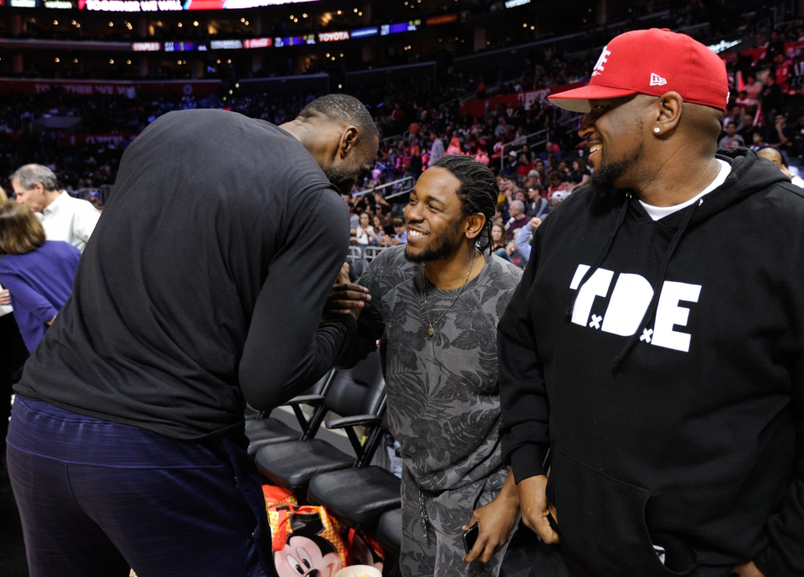 LOS ANGELES, CA - MARCH 13:  Kendrick Lamar (C) greets LeBron James at a basketball game between the Cleveland Cavaliers and the Los Angeles Clippers at Staples Center on March 13, 2016 in Los Angeles, California.  (Photo by Noel Vasquez/GC Images)