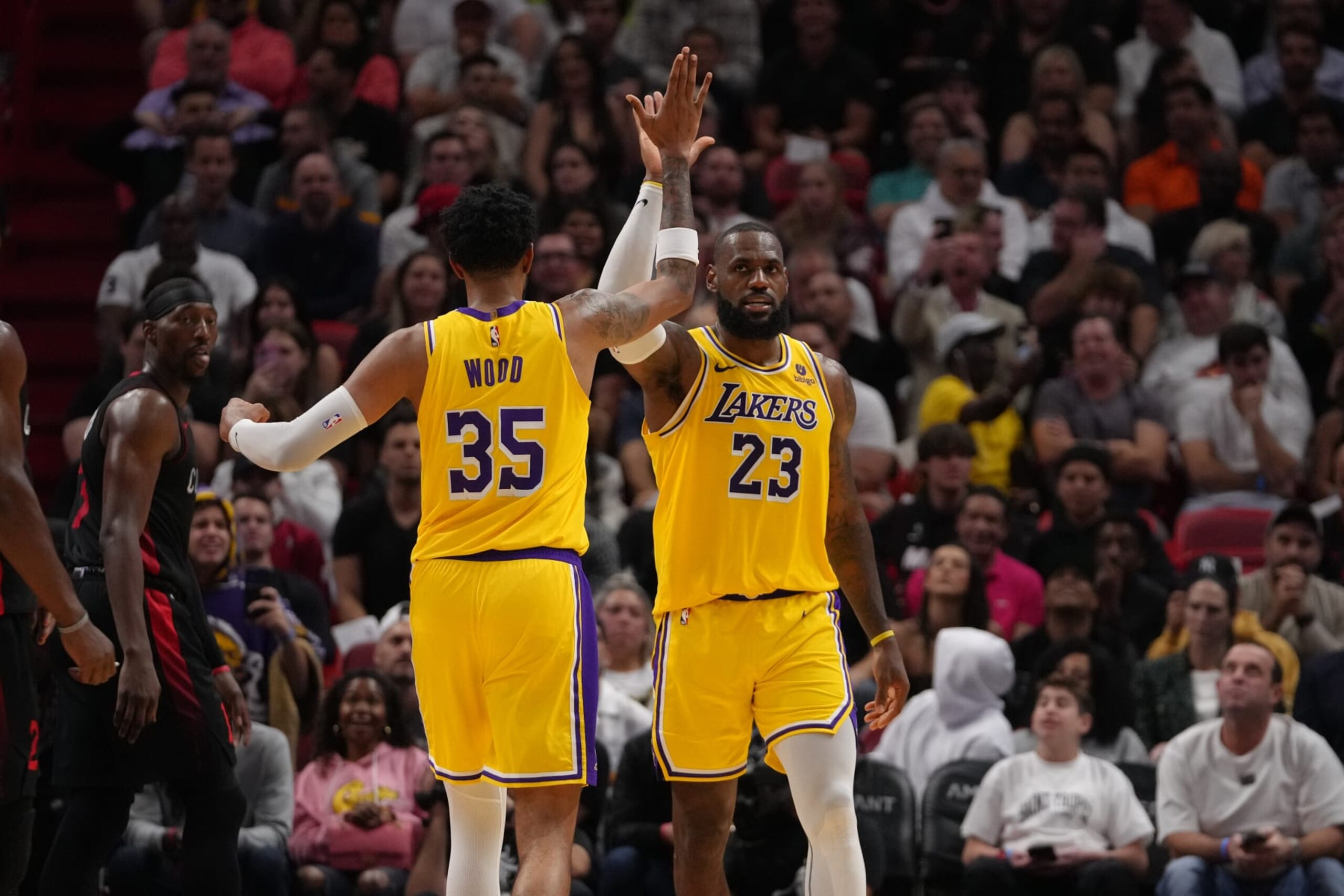 MIAMI, FLORIDA - NOVEMBER 6: LeBron James #23 and Christian Wood #35 of the Los Angeles Lakers high five during the game against the Miami Heat on November 6, 2023 at Kaseya Center in Miami, Florida. NOTE TO USER: User expressly acknowledges and agrees that, by downloading and or using this Photograph, user is consenting to the terms and conditions of the Getty Images License Agreement. Mandatory Copyright Notice: Copyright 2023 NBAE (Photo by Eric Espada/NBAE via Getty Images)