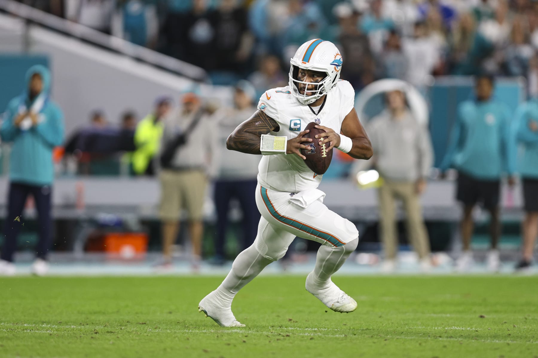 MIAMI GARDENS, FL - JANUARY 07: Tua Tagovailoa #1 of the Miami Dolphins scrambles out of the pocket during an NFL football game against the Buffalo Bills at Hard Rock Stadium on January 7, 2024 in Miami Gardens, Florida. (Photo by Perry Knotts/Getty Images)