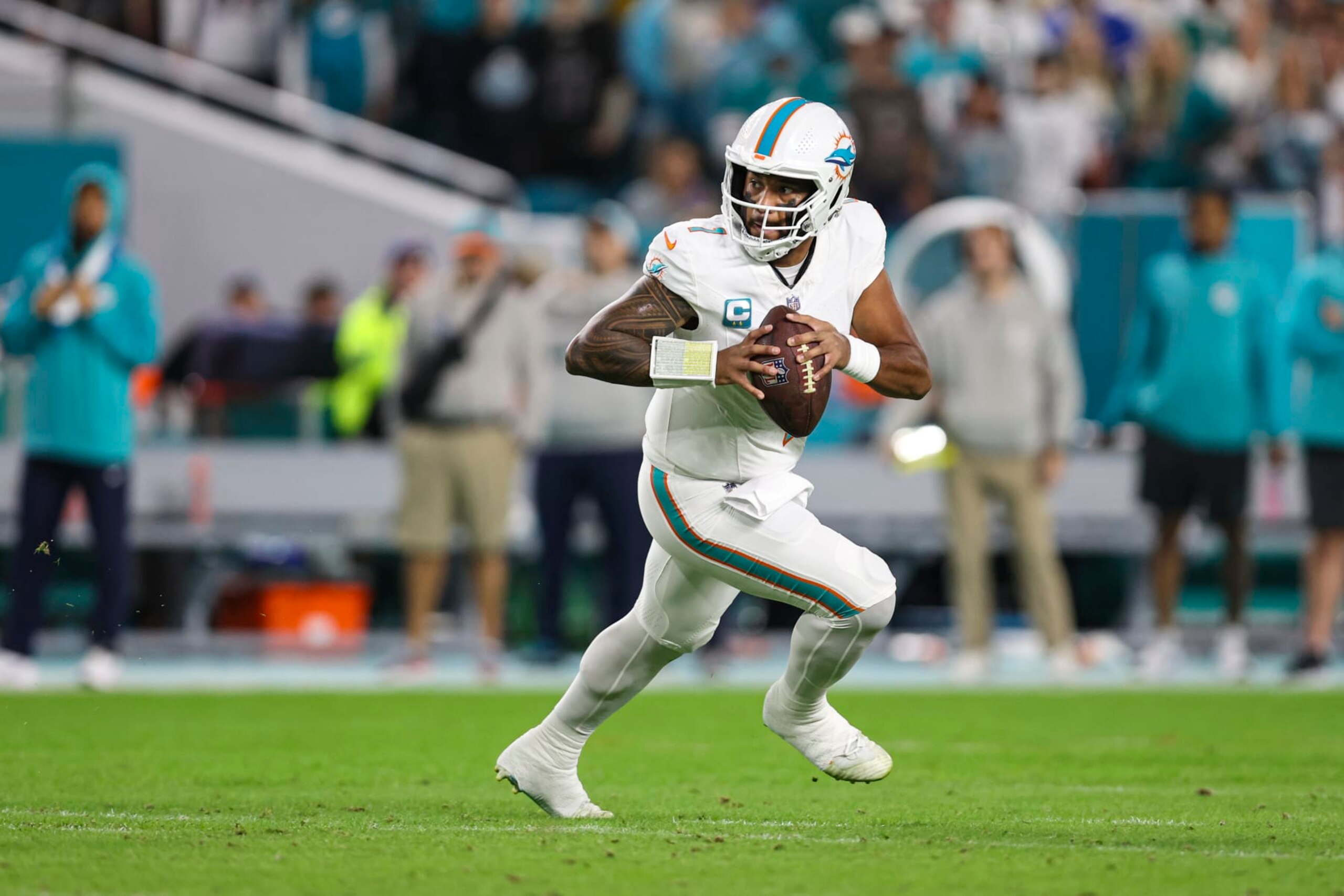 MIAMI GARDENS, FL - JANUARY 07: Tua Tagovailoa #1 of the Miami Dolphins scrambles out of the pocket during an NFL football game against the Buffalo Bills at Hard Rock Stadium on January 7, 2024 in Miami Gardens, Florida. (Photo by Perry Knotts/Getty Images)