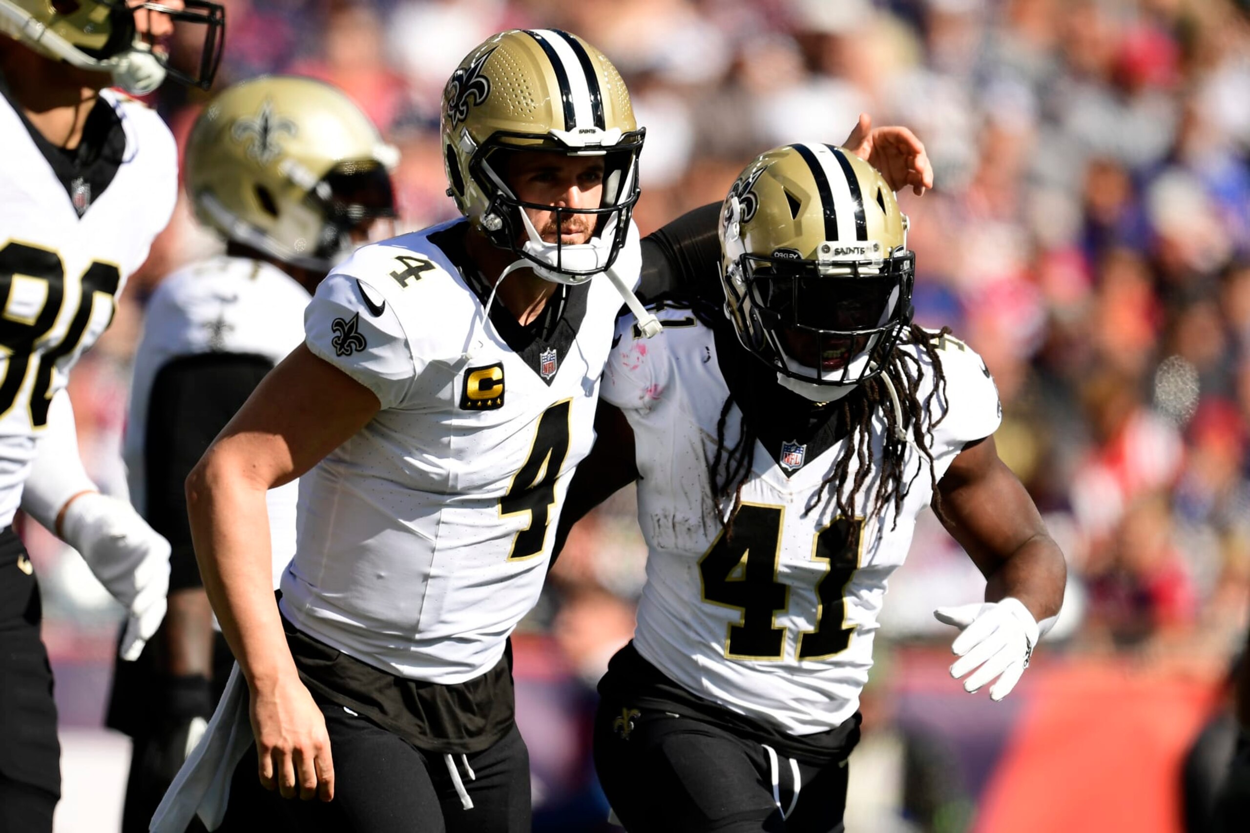 FOXBOROUGH, MASSACHUSETTS - OCTOBER 08: Derek Carr #4 of the New Orleans Saints and Alvin Kamara #41 of the New Orleans Saints celebrate after Kamara's rushing touchdown during the second quarter against the New England Patriots at Gillette Stadium on October 08, 2023 in Foxborough, Massachusetts. (Photo by Maddie Malhotra/Getty Images)