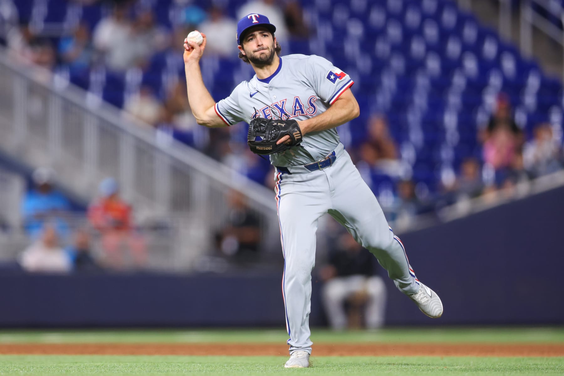 MIAMI, FLORIDA - MAY 31: Josh Smith #8 of the Texas Rangers throws the ball to first base against the Miami Marlins during the sixth inning of the game at loanDepot park on May 31, 2024 in Miami, Florida. (Photo by Megan Briggs/Getty Images)