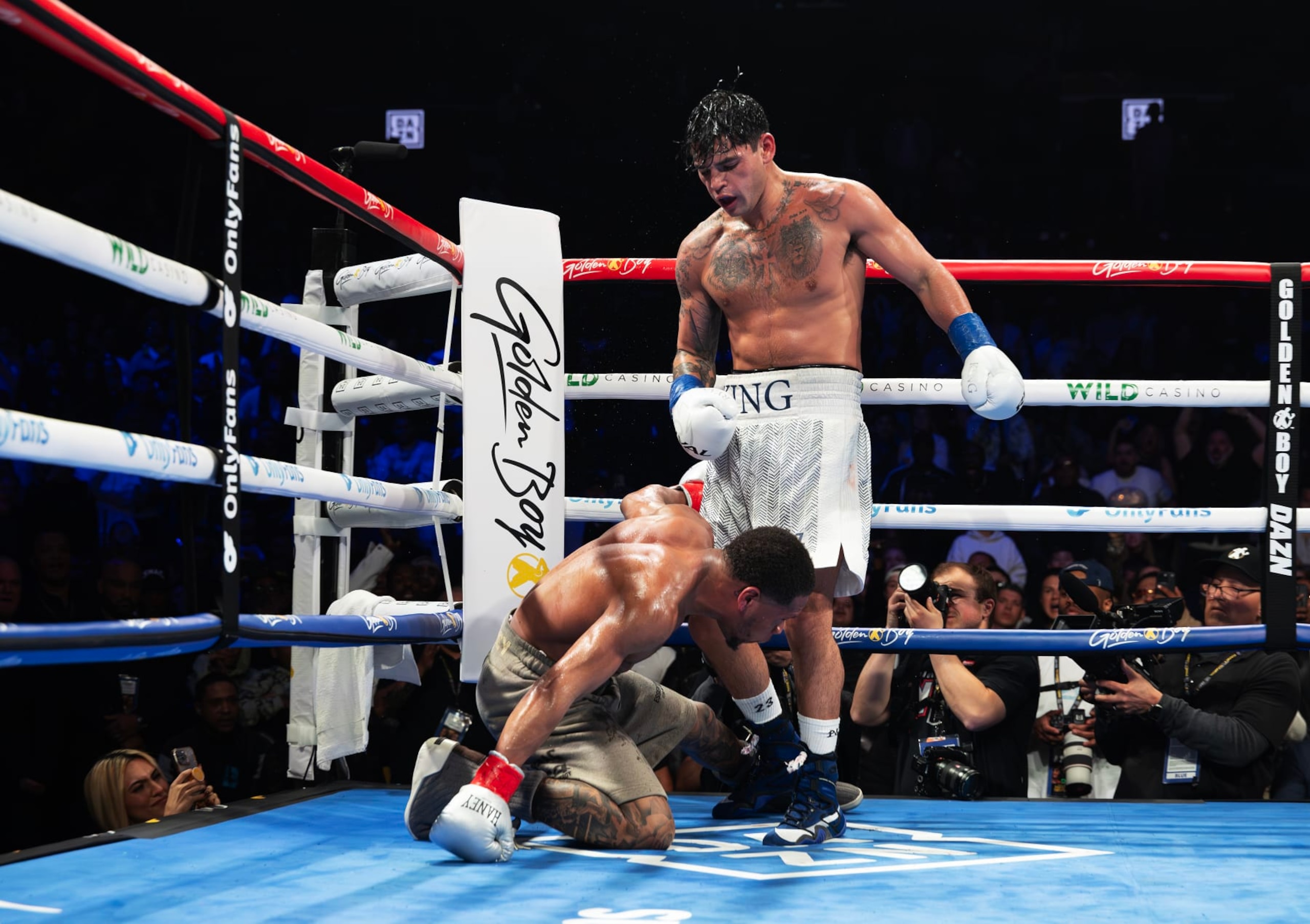 NEW YORK, NEW YORK - APRIL 20: Ryan Garcia (white trunks) knocks down Devin Haney (gray trunks) during their WBC Super Lightweight title bout at Barclays Center on April 20, 2024 in New York City. (Photo by Al Bello/Getty Images) NEW YORK, NEW YORK - APRIL 20: Ryan Garcia (white trunks) knocks down Devin Haney (gray trunks) during their WBC Super Lightweight title bout at Barclays Center on April 20, 2024 in New York City. (Photo by Al Bello/Getty Images)