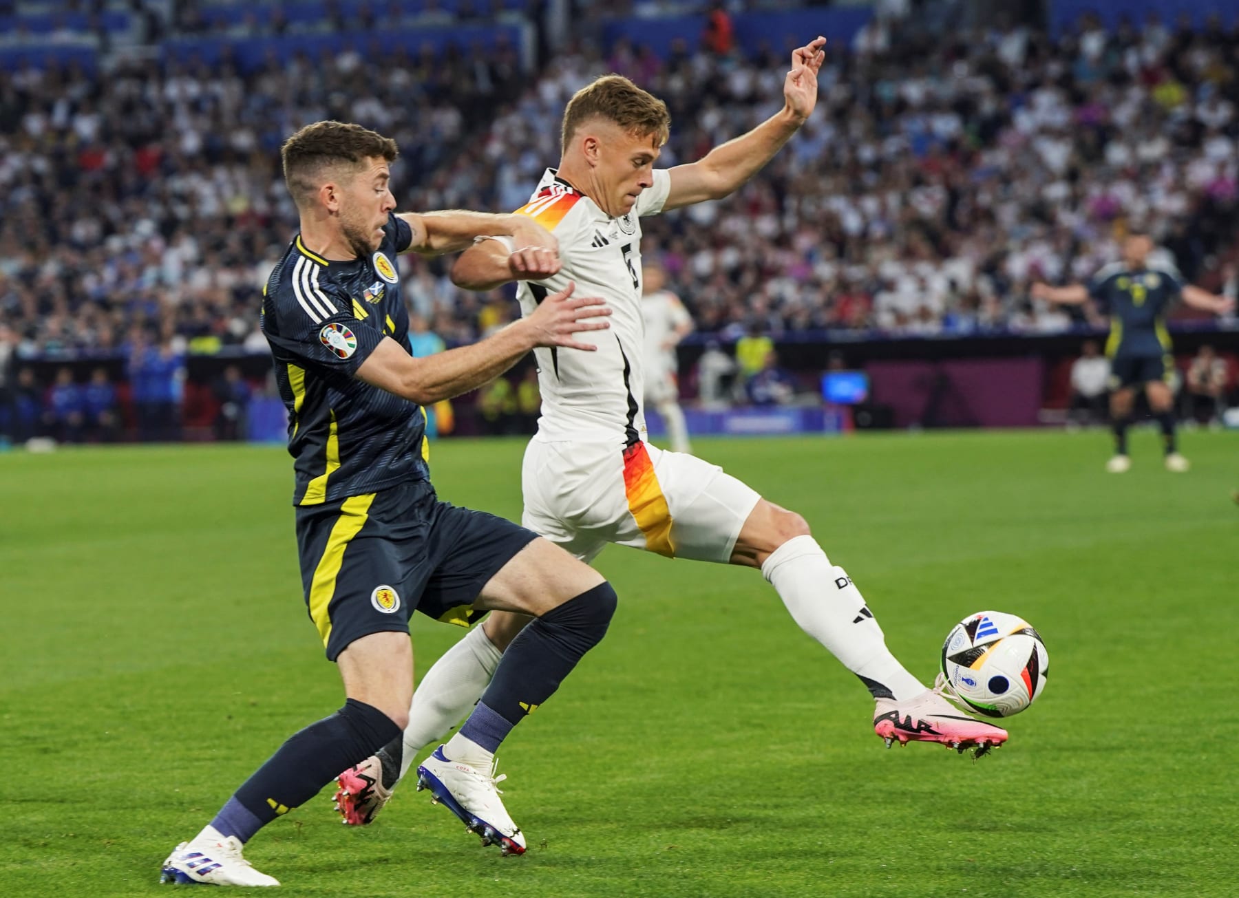 Joshua Kimmich R of Germany competes during the UEFA Euro 2024 Group A match between Germany and Scotland in Munich, Germany on June 14, 2024. (Photo by Peng Ziyang/Xinhua via Getty Images)