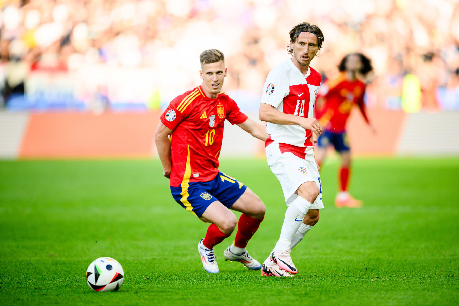 BERLIN, GERMANY - JUNE 15: Luka Modric (R) of Croatia is tackled by Dani Olmo (L) of Spain during the UEFA EURO 2024 group stage match between Spain and Croatia at Olympiastadion on June 15, 2024 in Berlin, Germany. (Photo by Marvin Ibo Guengoer - GES Sportfoto/Getty Images)