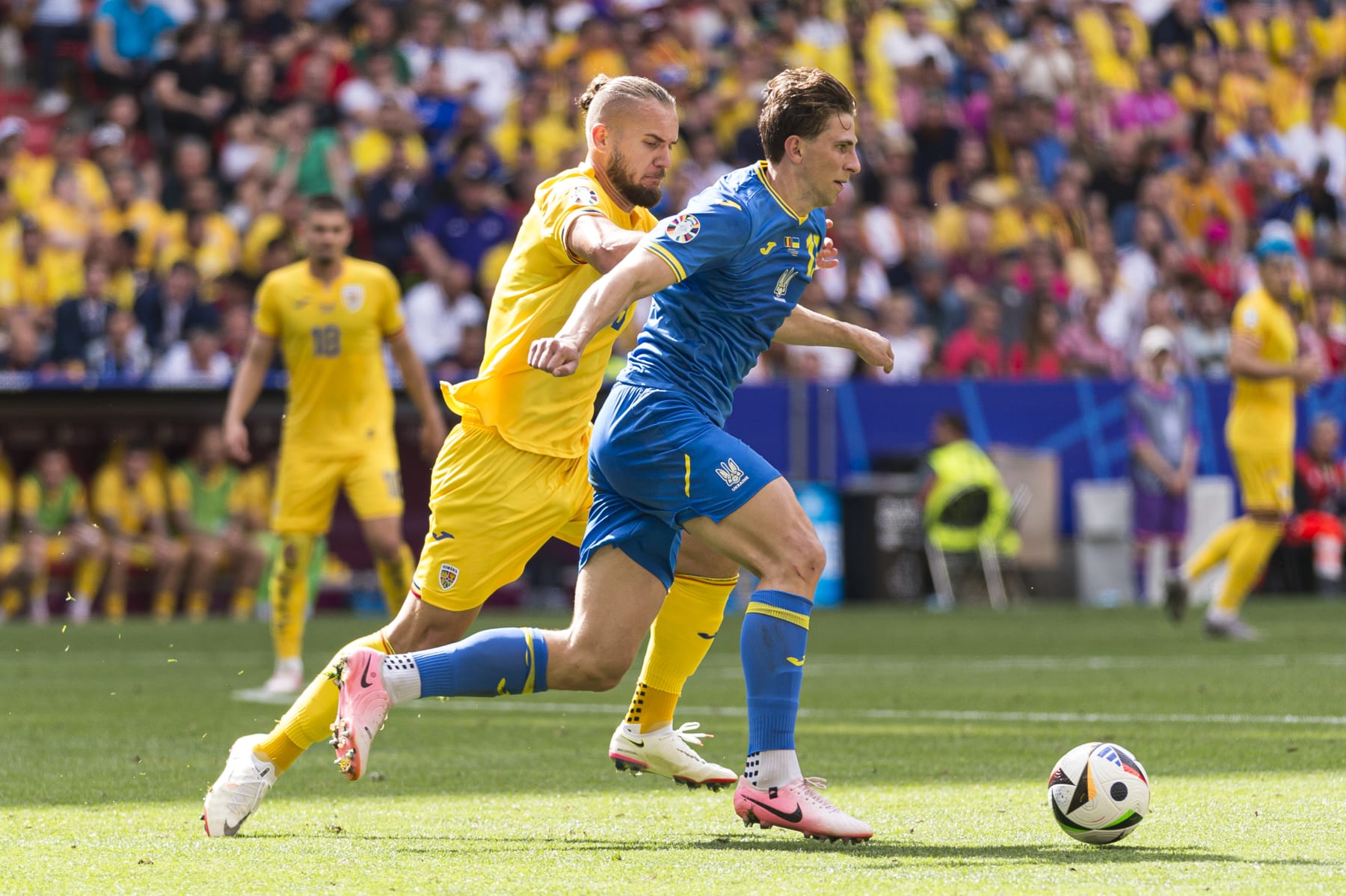 MUNICH, GERMANY - JUNE 17: Illya Zabarnyi of Ukraine (R) dribbles George Puscas of Romania (L) during the UEFA EURO 2024 group stage match between Romania and Ukraine at Munich Football Arena on June 17, 2024 in Munich, Germany. (Photo by Sven Beyrich/Eurasia Sport Images/Getty Images)