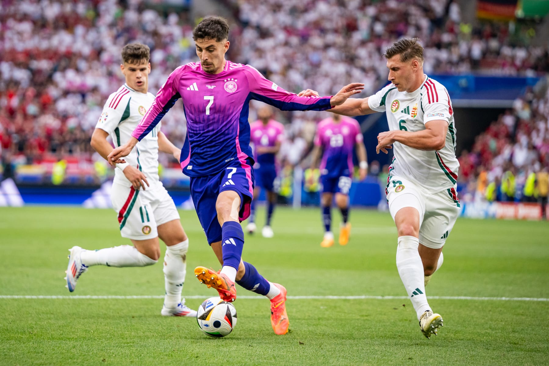 STUTTGART, GERMANY - JUNE 19: Milos Kerkez of Hungary, Kai Havertz of Germany and Willi Orban of Hungary in action during the UEFA EURO 2024 group stage match between Germany and Hungary at Stuttgart Arena on June 19, 2024 in Stuttgart, Germany. (Photo by Kevin Voigt/Getty Images)