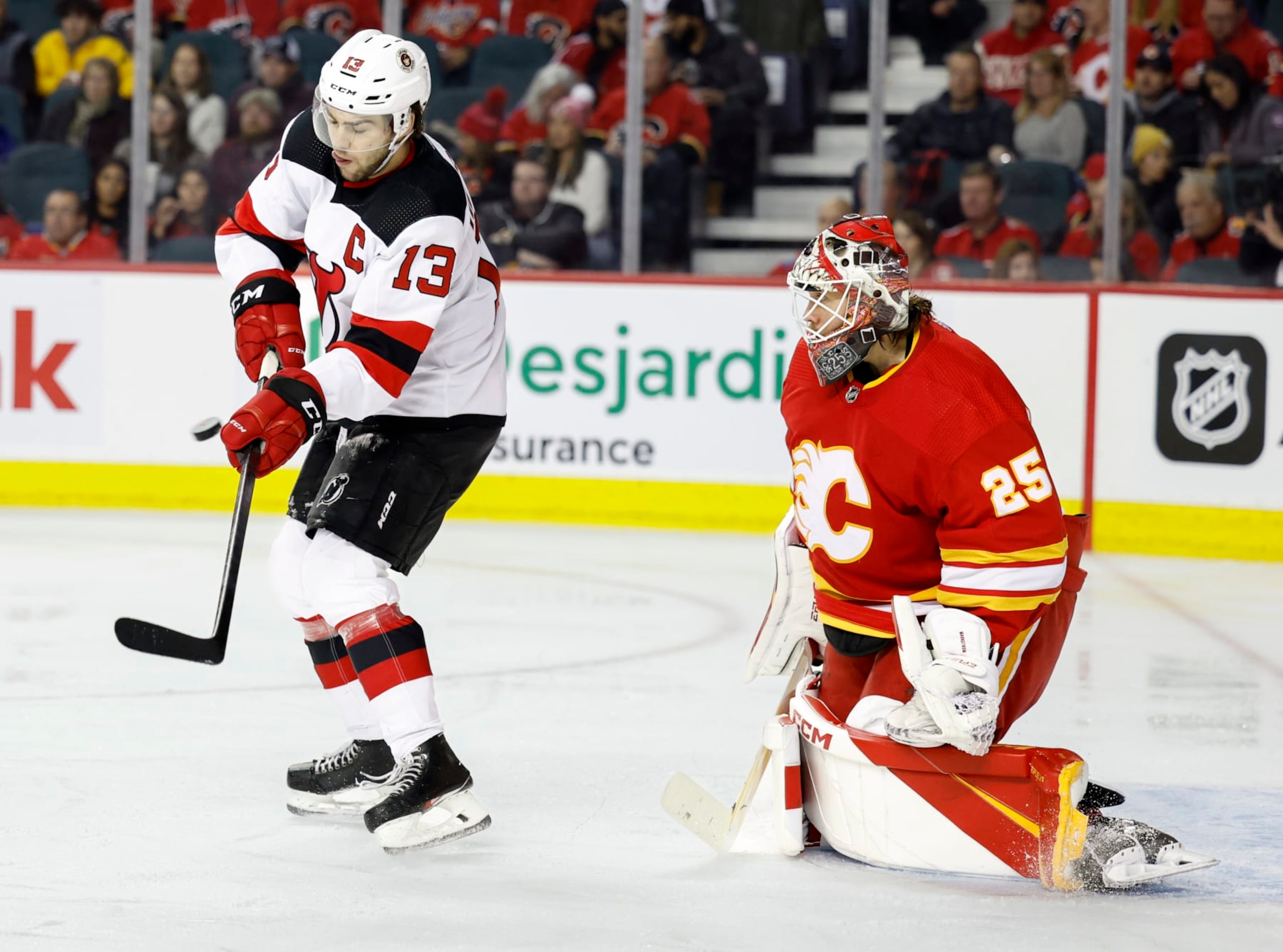 CALGARY, CANADA - NOVEMBER 05: Nico Hischier #13 of the New Jersey Devils tries to tip the puck in front of Jacob Markstrom #25 of the Calgary Flames at the Scotiabank Saddledome on November 5, 2022, in Calgary, Alberta, Canada. (Photo by Leah Hennel/Getty Images) CALGARY, CANADA - NOVEMBER 05: Nico Hischier #13 of the New Jersey Devils tries to tip the puck in front of Jacob Markstrom #25 of the Calgary Flames at the Scotiabank Saddledome on November 5, 2022, in Calgary, Alberta, Canada. (Photo by Leah Hennel/Getty Images)