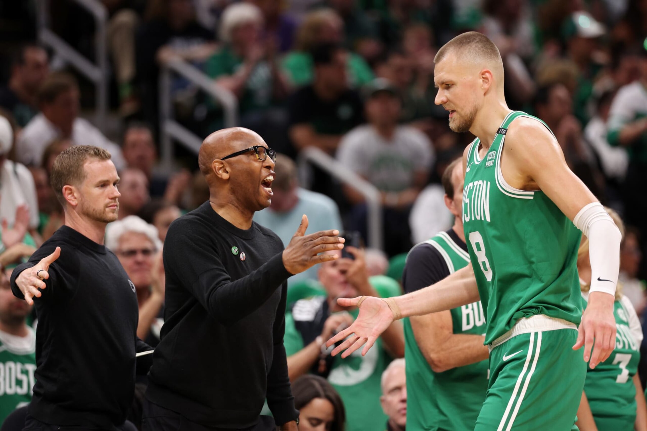 BOSTON, MASSACHUSETTS - JUNE 17: Assistant coach Sam Cassell high fives Kristaps Porzingis #8 of the Boston Celtics after a play against the Dallas Mavericks during the second quarter of Game Five of the 2024 NBA Finals at TD Garden on June 17, 2024 in Boston, Massachusetts. NOTE TO USER: User expressly acknowledges and agrees that, by downloading and or using this photograph, User is consenting to the terms and conditions of the Getty Images License Agreement. (Photo by Elsa/Getty Images)