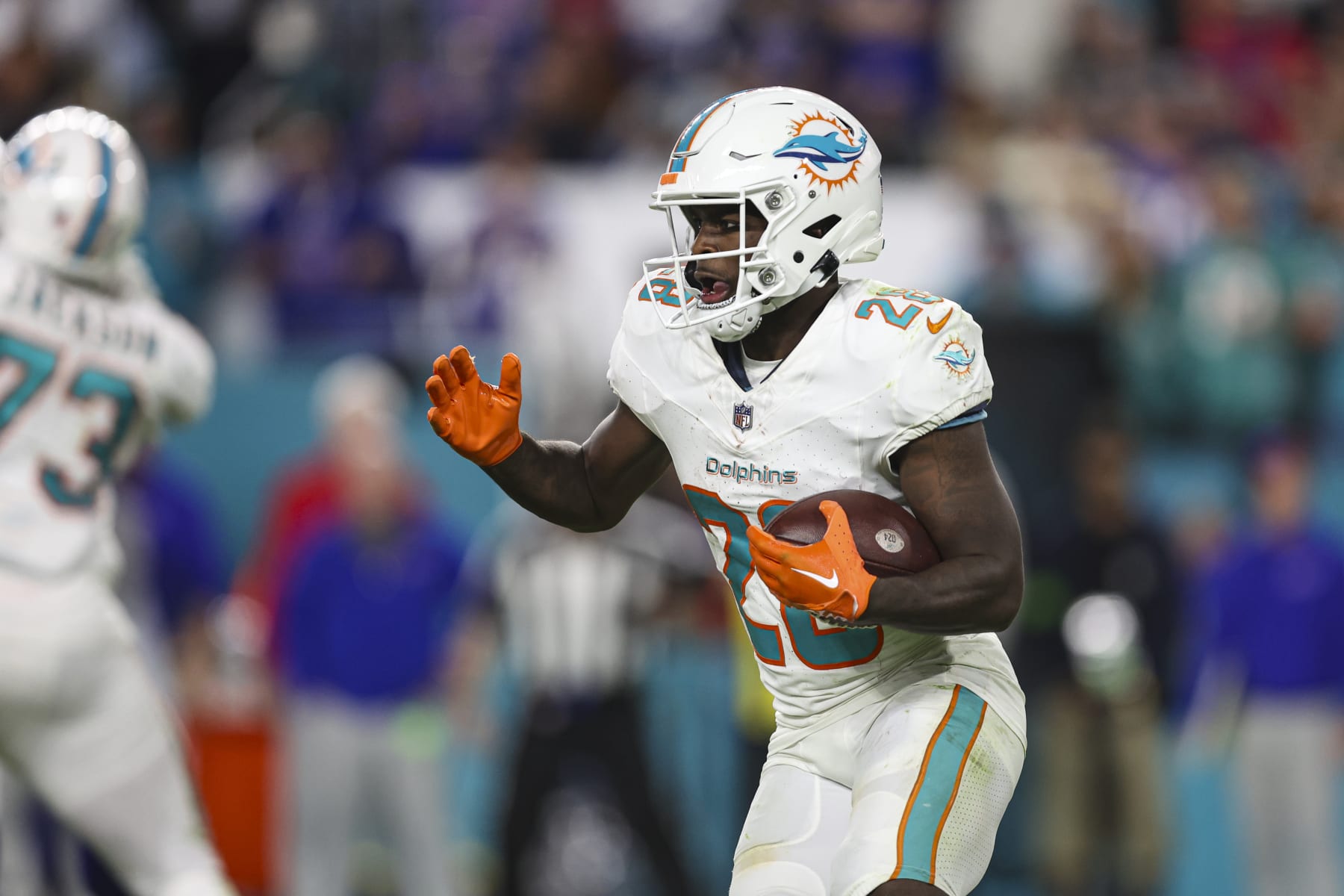 MIAMI GARDENS, FL - JANUARY 07: De'Von Achane #28 of the Miami Dolphins runs the ball during an NFL football game against the Buffalo Bills at Hard Rock Stadium on January 7, 2024 in Miami Gardens, Florida. (Photo by Perry Knotts/Getty Images)