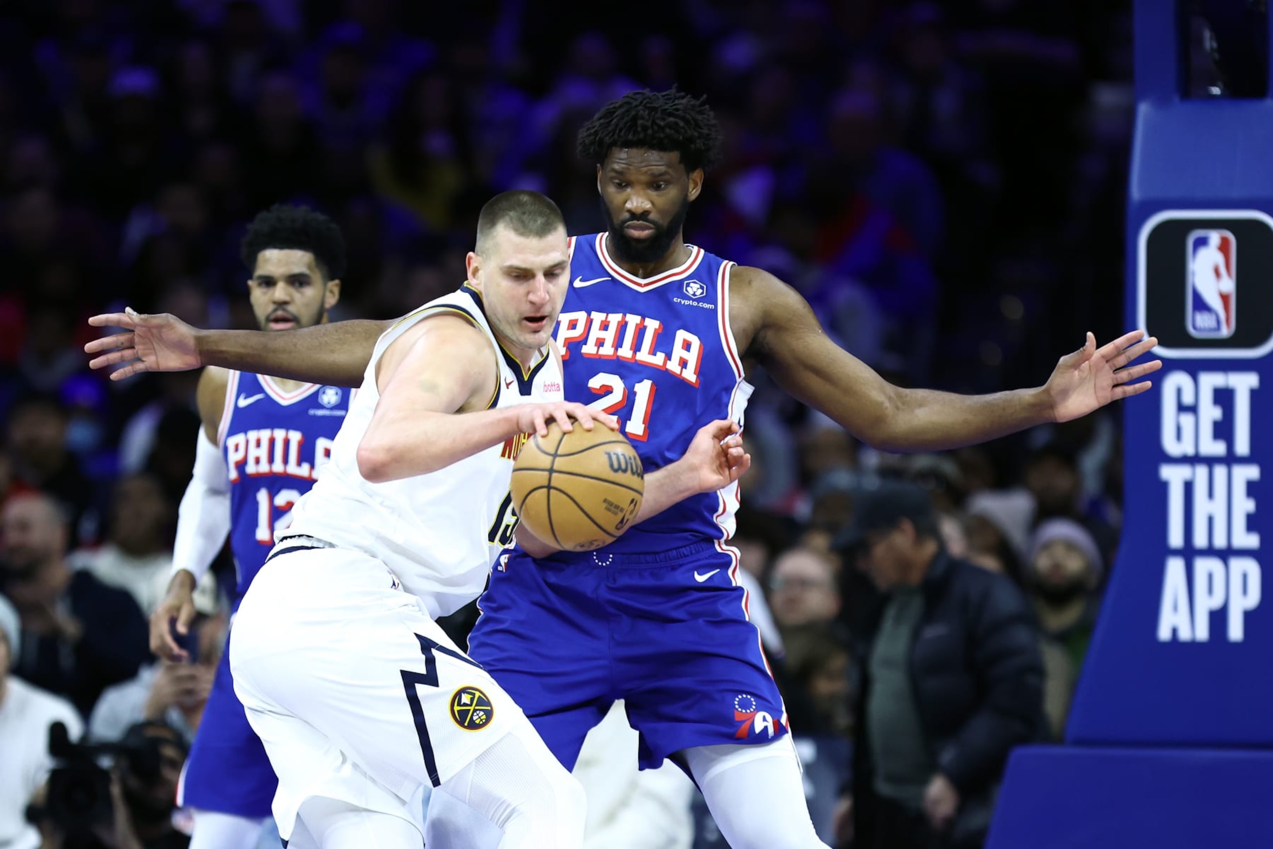 PHILADELPHIA, PENNSYLVANIA - JANUARY 16: Nikola Jokic #15 of the Denver Nuggets is guarded by Joel Embiid #21 of the Philadelphia 76ers during the first quarter at the Wells Fargo Center on January 16, 2024 in Philadelphia, Pennsylvania. NOTE TO USER: User expressly acknowledges and agrees that, by downloading and or using this photograph, User is consenting to the terms and conditions of the Getty Images License Agreement. (Photo by Tim Nwachukwu/Getty Images)