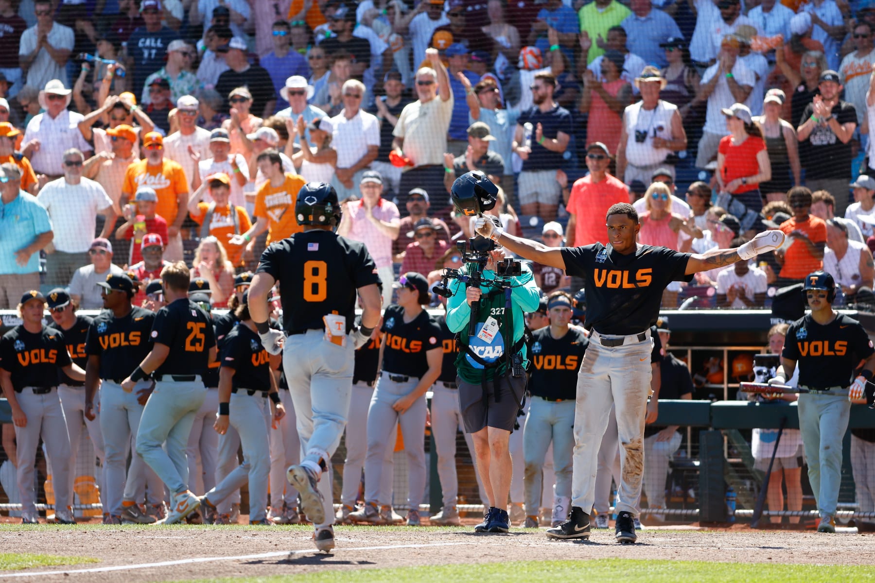 OMAHA, NEBRASKA - JUNE 23: Christian Moore #1 celebrates with Dylan Dreiling #8 of the Tennessee Volunteers after a 2-run home run against the Texas A&M Aggies in the seventh inning during game two of the Division I Men's Baseball Championship held at Charles Schwab Field on June 23, 2024 in Omaha, Nebraska.  (Photo by C. Morgan Engel/NCAA Photos via Getty Images)