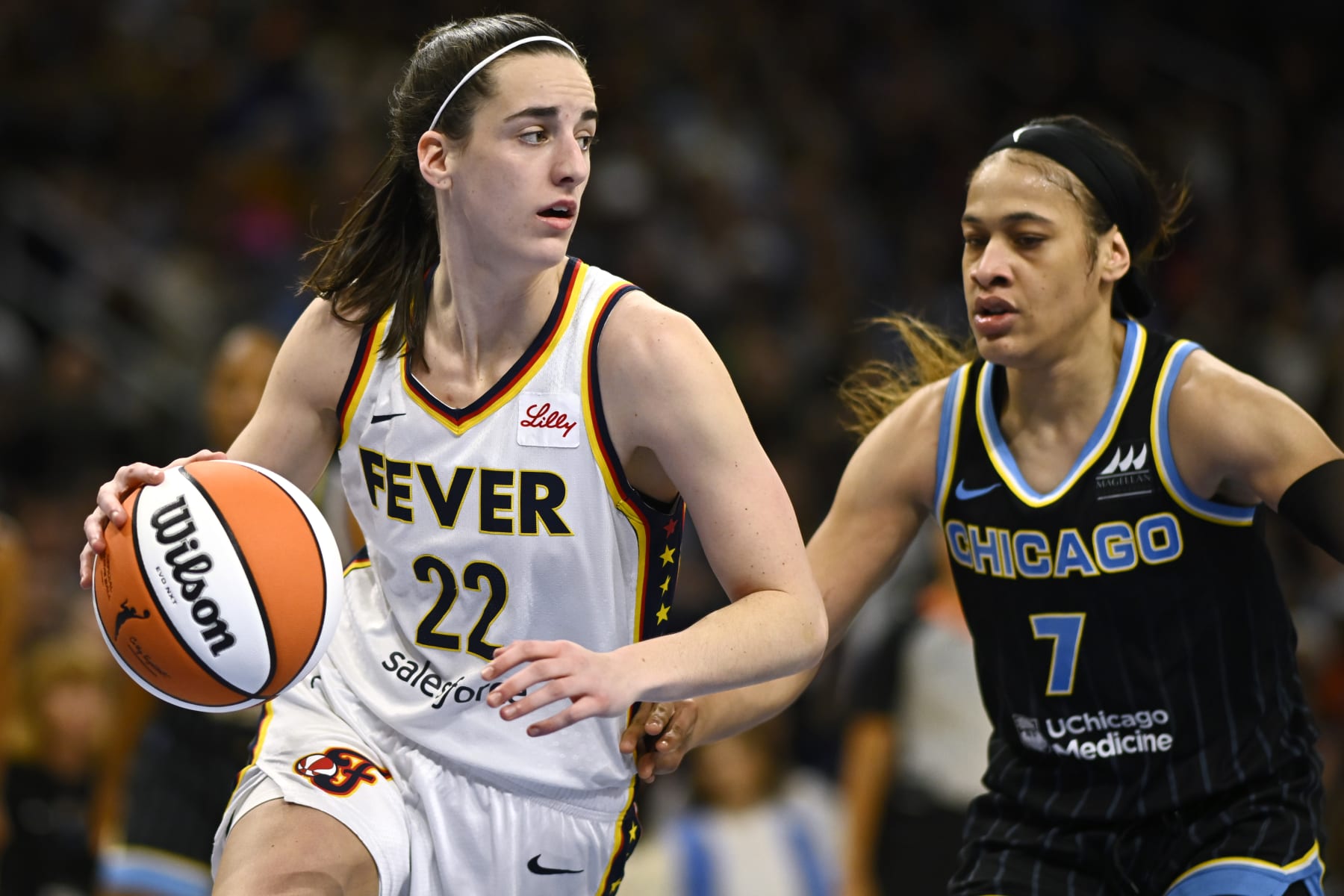 CHICAGO, ILLINOIS - JUNE 23: Caitlin Clark #22 of the Indiana Fever drives in the second half against Chennedy Carter #7 of the Chicago Sky at Wintrust Arena on June 23, 2024 in Chicago, Illinois.  NOTE TO USER: User expressly acknowledges and agrees that, by downloading and or using this photograph, User is consenting to the terms and conditions of the Getty Images License Agreement. (Photo by Quinn Harris/Getty Images)