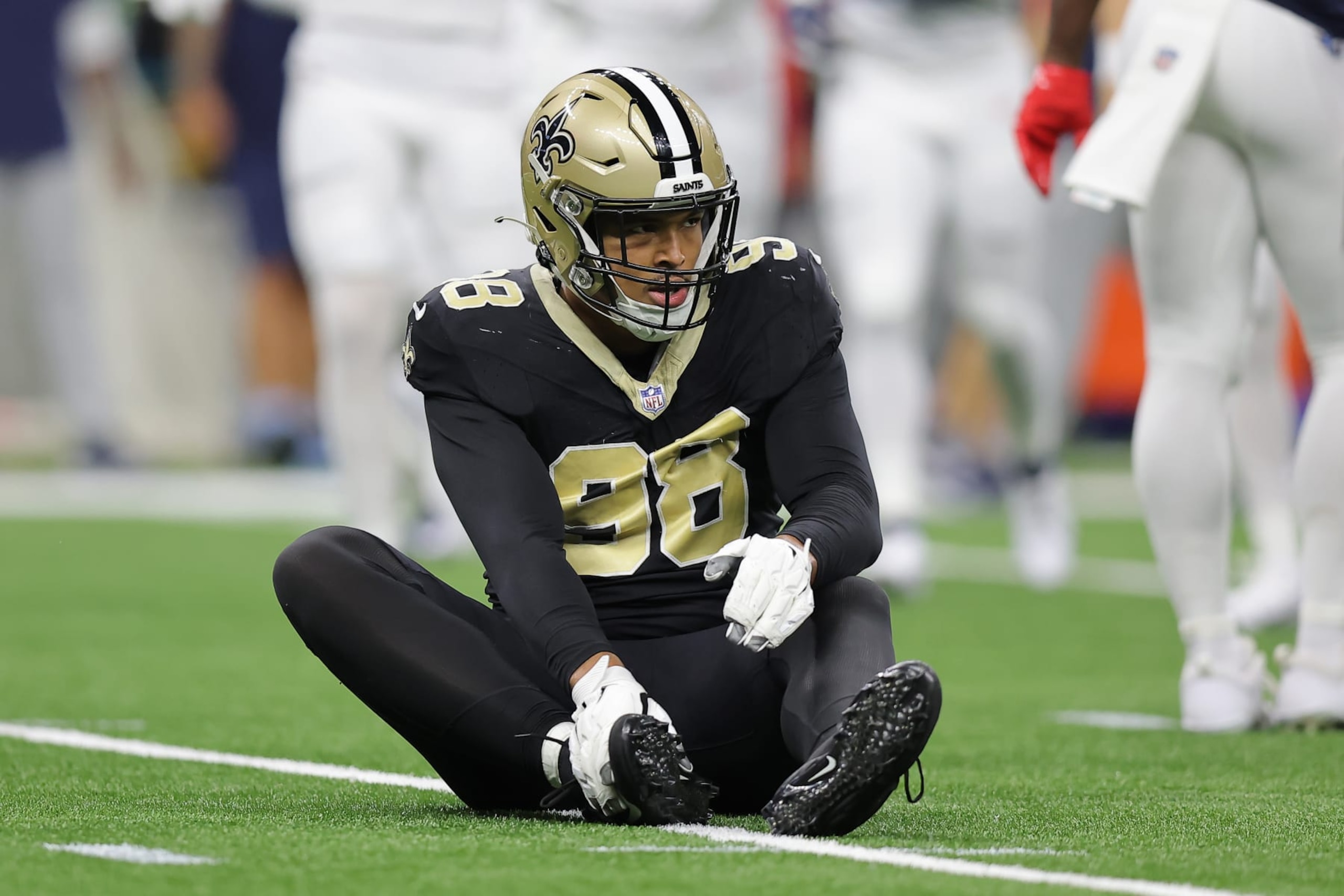NEW ORLEANS, LOUISIANA - SEPTEMBER 10: Payton Turner #98 of the New Orleans Saints tends to an injury during the second quarter against the Tennessee Titans at Caesars Superdome on September 10, 2023 in New Orleans, Louisiana. (Photo by Jonathan Bachman/Getty Images)