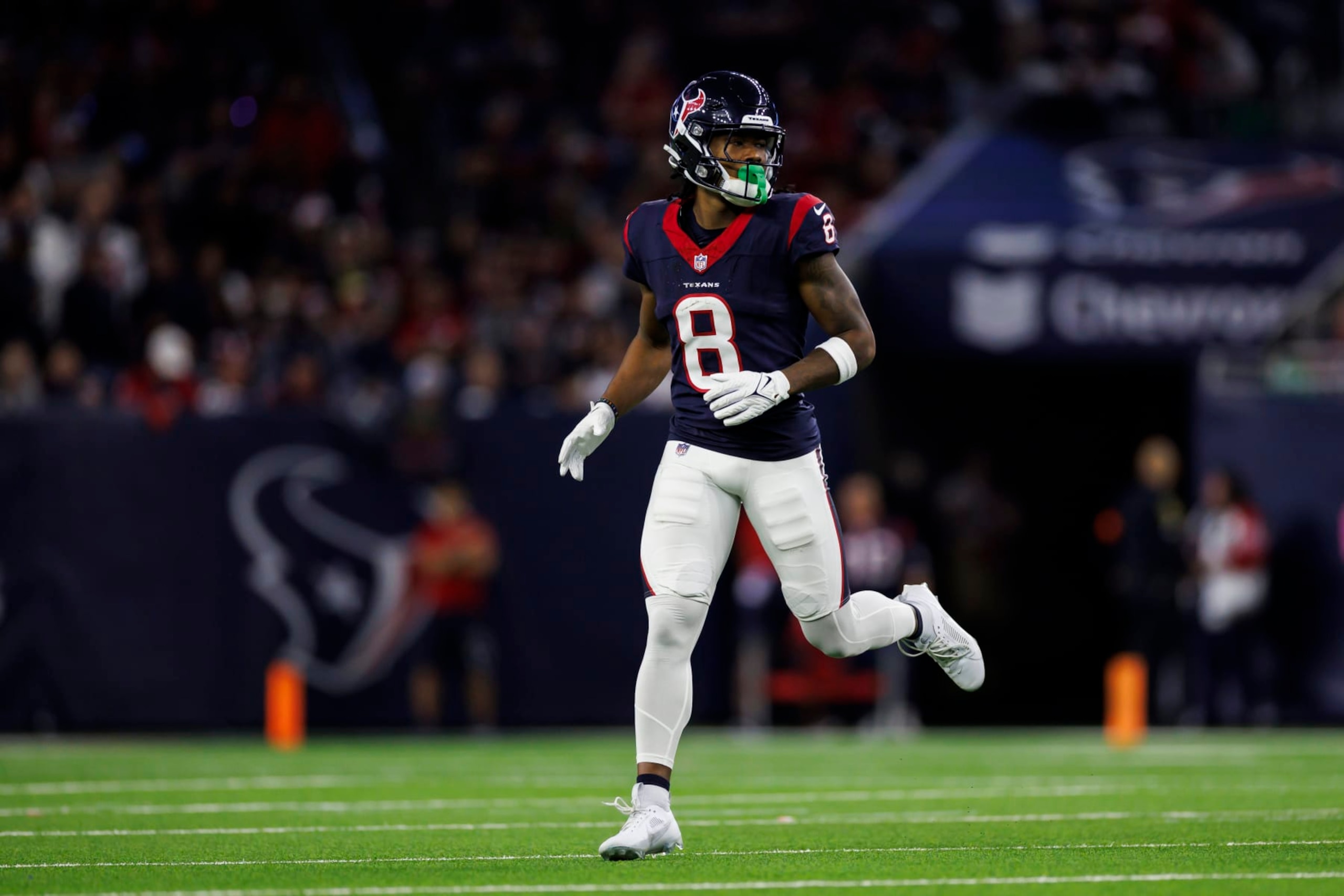 HOUSTON, TEXAS - JANUARY 13: John Metchie III #8 of the Houston Texans lines up to run a route during an AFC wild-card playoff football game against the Cleveland Browns at NRG Stadium on January 13, 2024 in Houston, Texas. (Photo by Ryan Kang/Getty Images)