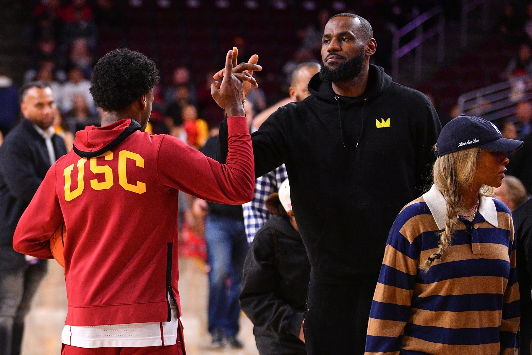 LOS ANGELES, CA - JANUARY 06: USC Trojans guard Bronny James (6) gives his dad LeBron James a high five before the college basketball game between the Stanford Cardinal and the USC Trojans on January 6, 2024 at Galen Center in Los Angeles, CA. (Photo by Brian Rothmuller/Icon Sportswire via Getty Images)