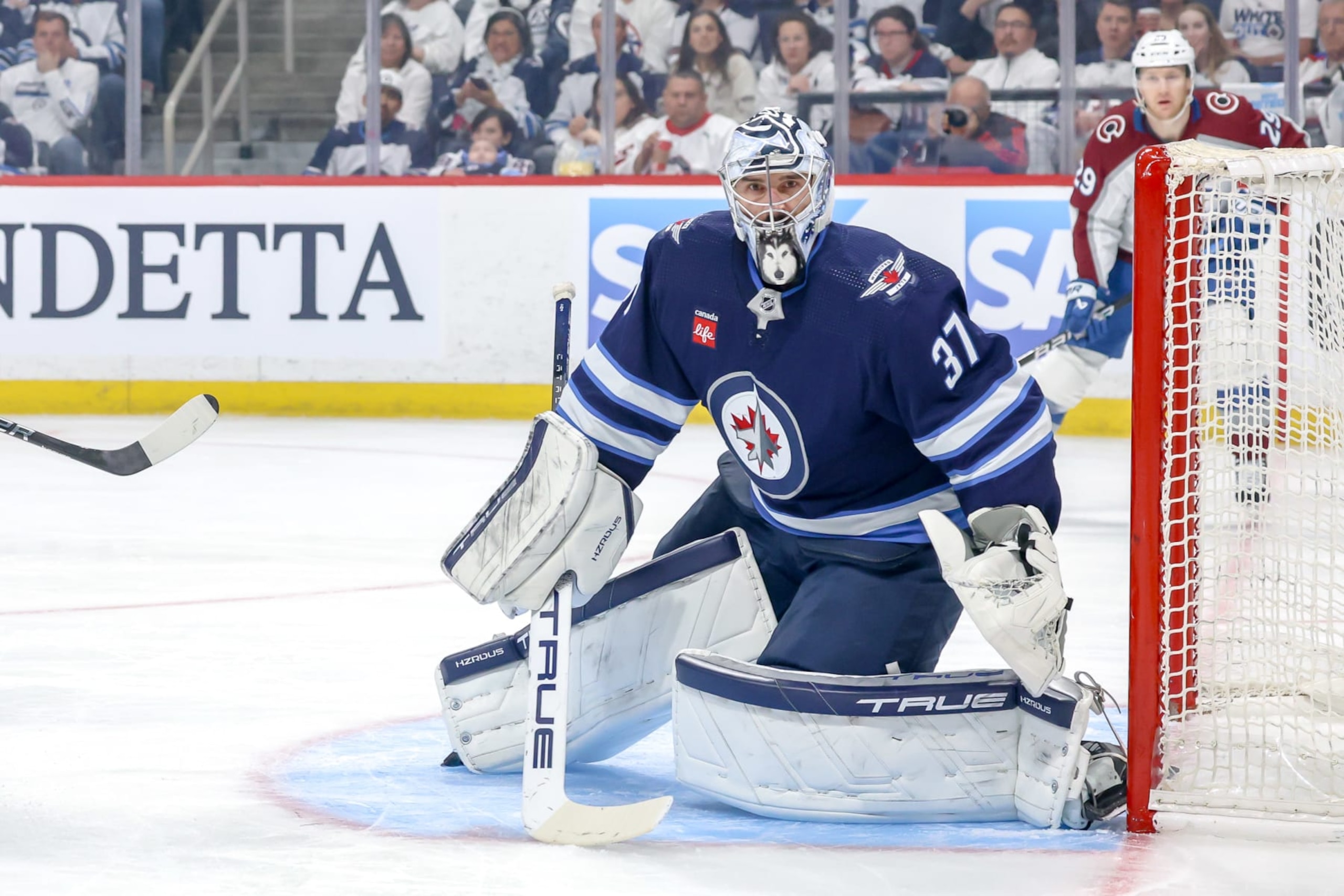 WINNIPEG, CANADA - APRIL 30: Goaltender Connor Hellebuyck #37 of the Winnipeg Jets keeps an eye on the play during first period action against the Colorado Avalanche in Game Five of the First Round of the 2024 Stanley Cup Playoffs at the Canada Life Centre on April 30, 2024 in Winnipeg, Manitoba, Canada. (Photo by Jonathan Kozub/NHLI via Getty Images)