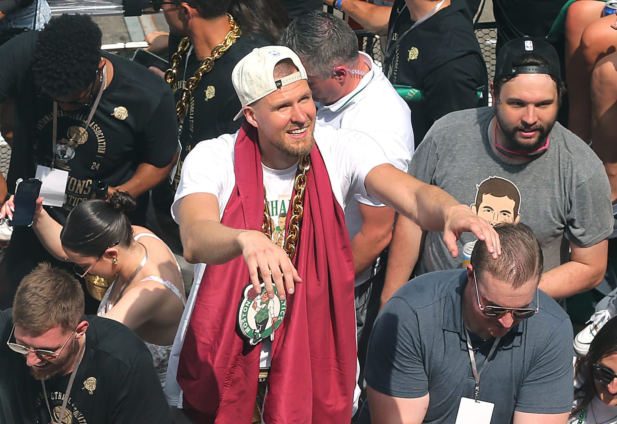 Boston, MA - June 21: Boston Celtics C Kristaps Porzingis waves to fans during a duck boat parade to celebrate the 18th Boston Celtics NBA championship. (Photo by John Tlumacki/The Boston Globe via Getty Images)