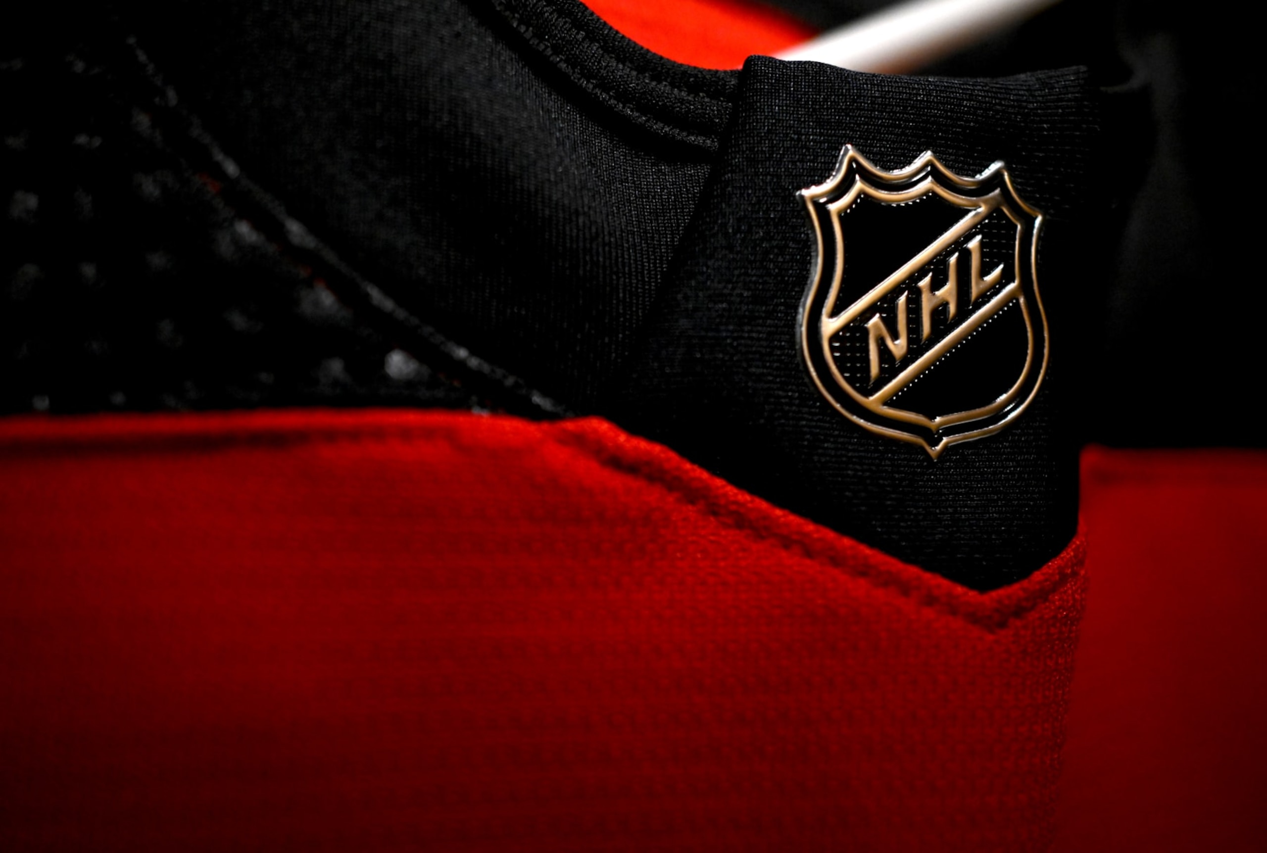 EAST RUTHERFORD, NEW JERSEY - FEBRUARY 17: A detailed view is seen of the NHL logo on a jersey in the New Jersey Devils locker room before the 2024 Navy Federal Credit Union Stadium Series game between the Philadelphia Flyers and the New Jersey Devils at MetLife Stadium on February 17, 2024 in East Rutherford, New Jersey. (Photo by Ben Jackson/NHLI via Getty Images)