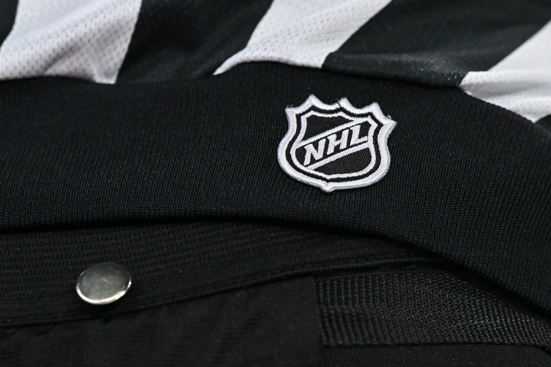 MONTREAL, CANADA - APRIL 16:  A detailed view of the NHL crest on a referee jersey during the shootout between the Montreal Canadiens and the Detroit Red Wings at the Bell Centre on April 16, 2024 in Montreal, Quebec, Canada.  The Detroit Red Wings defeated the Montreal Canadiens 5-4 in a shootout.  (Photo by Minas Panagiotakis/Getty Images)