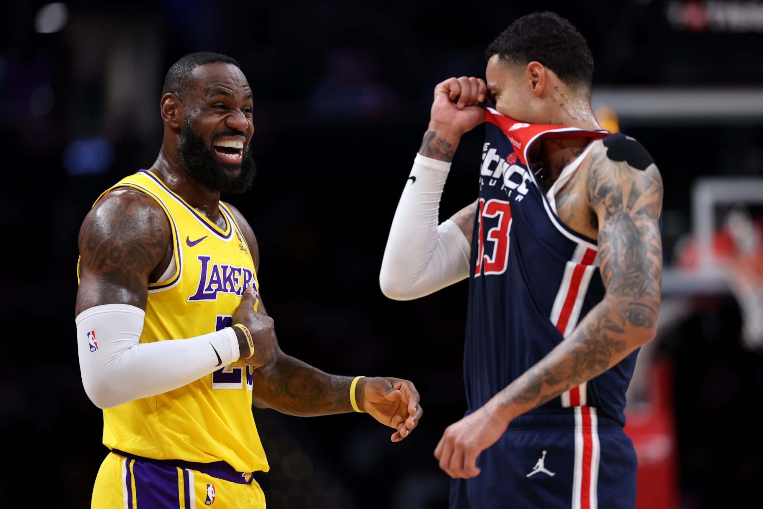 WASHINGTON, DC - APRIL 03: LeBron James #23 of the Los Angeles Lakers (L) and Kyle Kuzma #33 of the Washington Wizards share a laugh during the first half at Capital One Arena on April 03, 2024 in Washington, DC. NOTE TO USER: User expressly acknowledges and agrees that, by downloading and or using this photograph, User is consenting to the terms and conditions of the Getty Images License Agreement. (Photo by Patrick Smith/Getty Images)