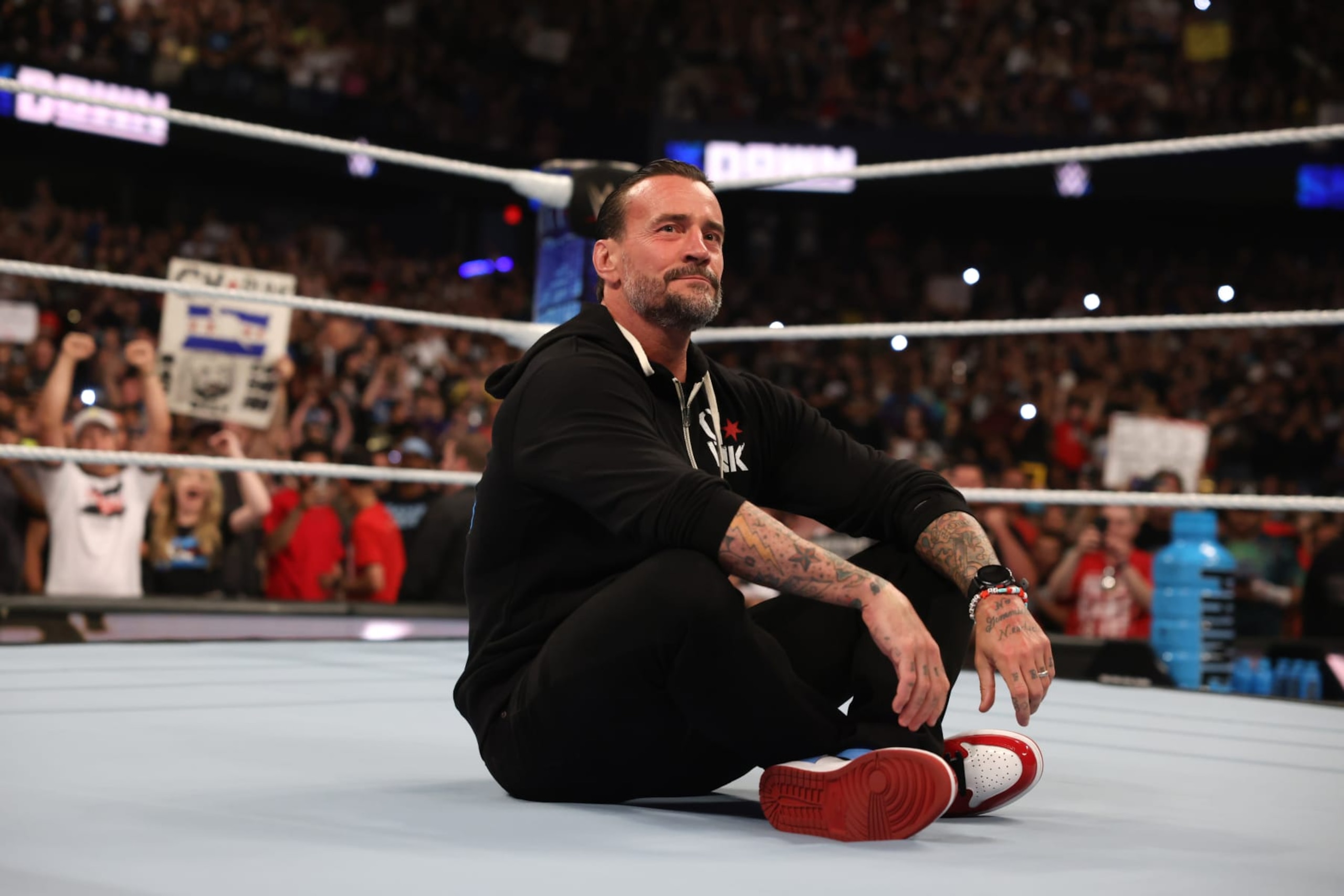 ROSEMONT, ILLINOIS - JUNE 21: CM Punk sits in the center of the ring and looks on during WWE SmackDown at Allstate Arena on June 21, 2024 in Rosemont, Illinois.  (Photo by WWE/Getty Images)