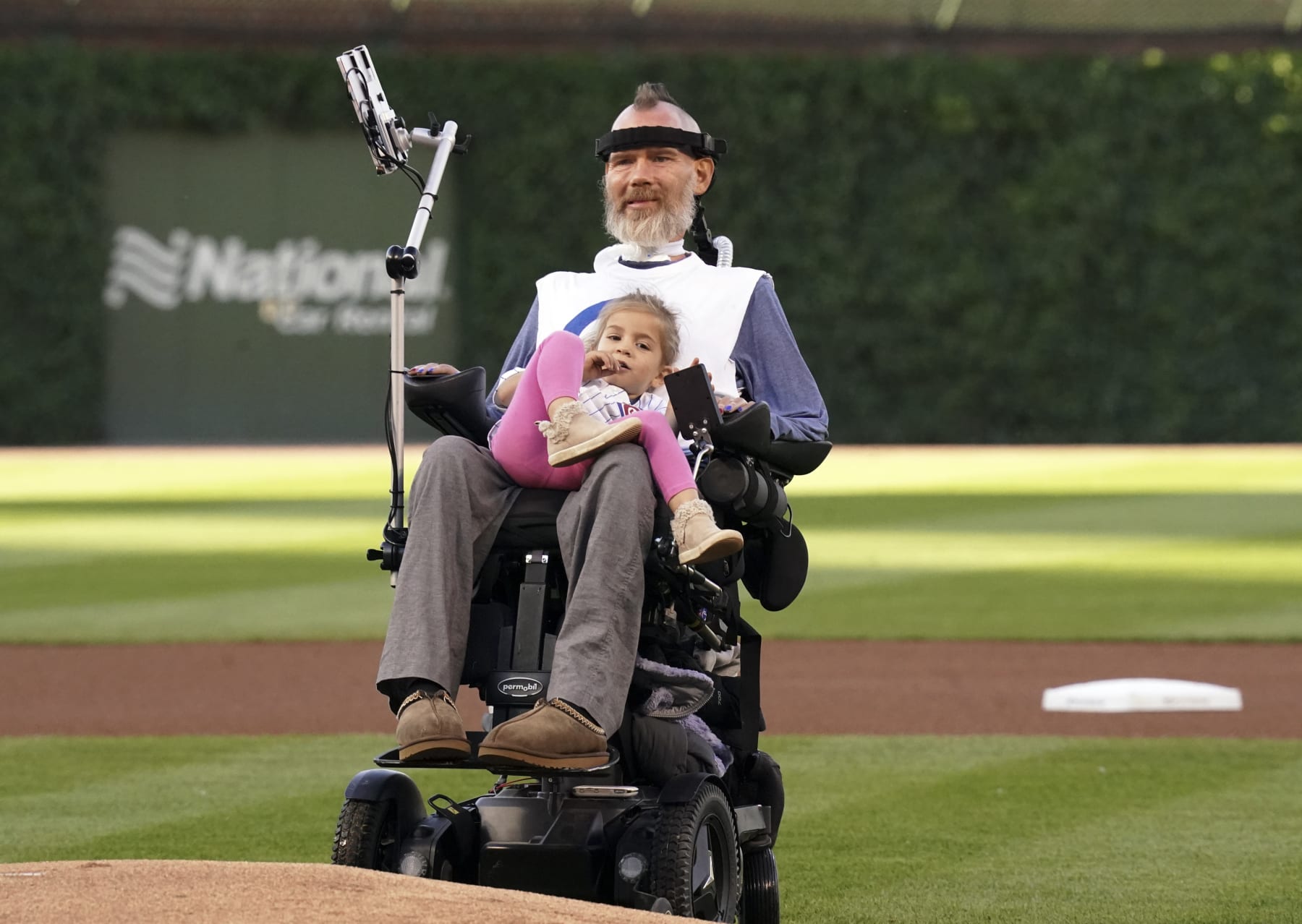 CHICAGO, ILLINOIS - JUNE 02:  Steve Gleason, a sufferer of Amyotrophic Lateral Sclerosis (ALS), holds his daughter Gray, 3 while watching his son Rivers throws the ceremonial first pitch of the game between the Chicago Cubs and the St. Louis Cardinals at Wrigley Field on June 02, 2022 in Chicago, Illinois. (Photo by Nuccio DiNuzzo/Getty Images)