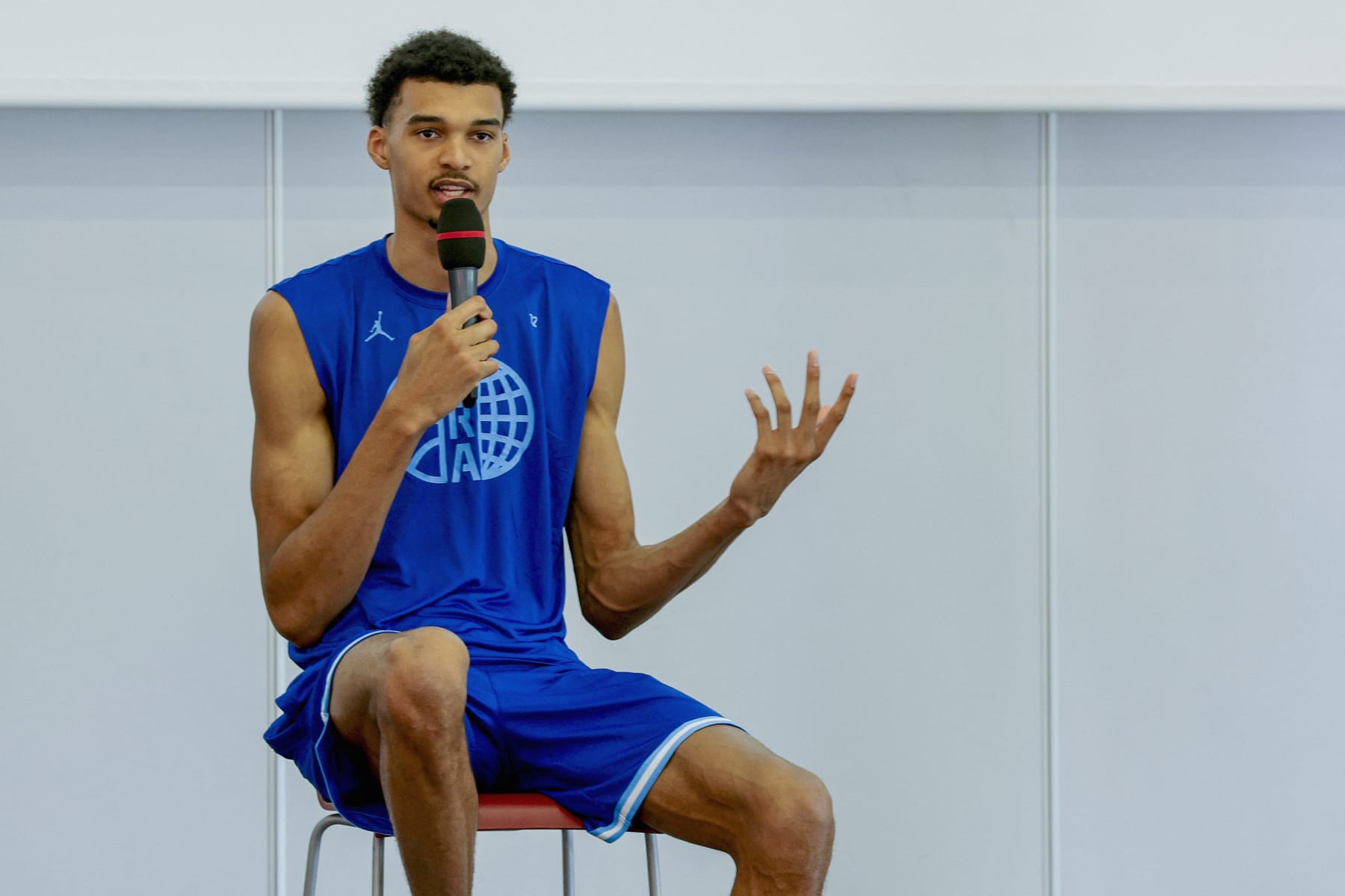 French basketball player Victor Wembanyama talks to the audience during a 5x5 France Olympics Basket Team Media Day in Paris, on June 27, 2024. France must avoid extremes in upcoming legislative elections, French basketball star Victor Wembanyama said on June 27, 2024, three days ahead of the first round of voting expected to be won by the far right. (Photo by Geoffroy VAN DER HASSELT / AFP) (Photo by GEOFFROY VAN DER HASSELT/AFP via Getty Images)