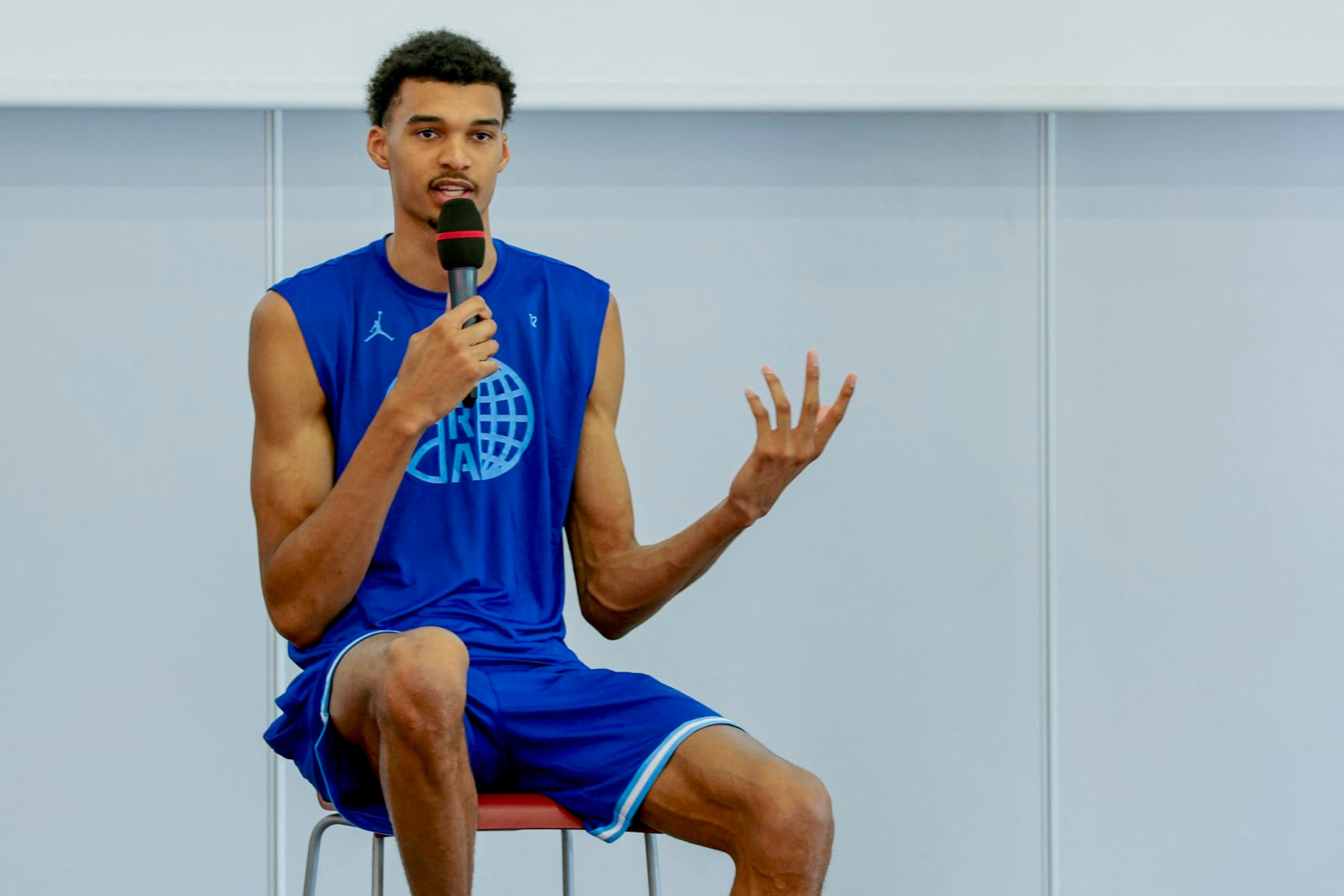 French basketball player Victor Wembanyama talks to the audience during a 5x5 France Olympics Basket Team Media Day in Paris, on June 27, 2024. France must avoid extremes in upcoming legislative elections, French basketball star Victor Wembanyama said on June 27, 2024, three days ahead of the first round of voting expected to be won by the far right. (Photo by Geoffroy VAN DER HASSELT / AFP) (Photo by GEOFFROY VAN DER HASSELT/AFP via Getty Images)