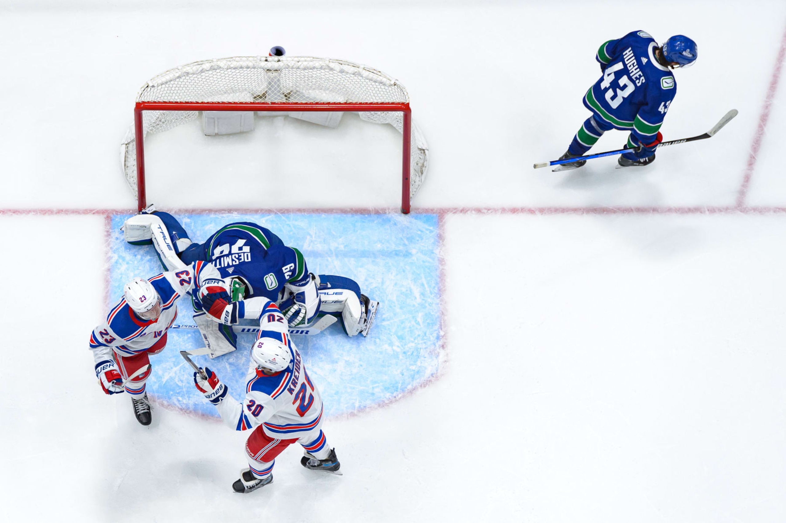 VANCOUVER, CANADA - OCTOBER 28: Adam Fox #23 is congratulated by Chris Kreider #20 of the New York Rangers after scoring a goal on Casey DeSmith #29 as Quinn Hughes #43 of the Vancouver Canucks skates on during the third period of their NHL game at Rogers Arena on October 28, 2023 in Vancouver, British Columbia, Canada. (Photo by Derek Cain/Getty Images) VANCOUVER, CANADA - OCTOBER 28: Adam Fox #23 is congratulated by Chris Kreider #20 of the New York Rangers after scoring a goal on Casey DeSmith #29 as Quinn Hughes #43 of the Vancouver Canucks skates on during the third period of their NHL game at Rogers Arena on October 28, 2023 in Vancouver, British Columbia, Canada. (Photo by Derek Cain/Getty Images)