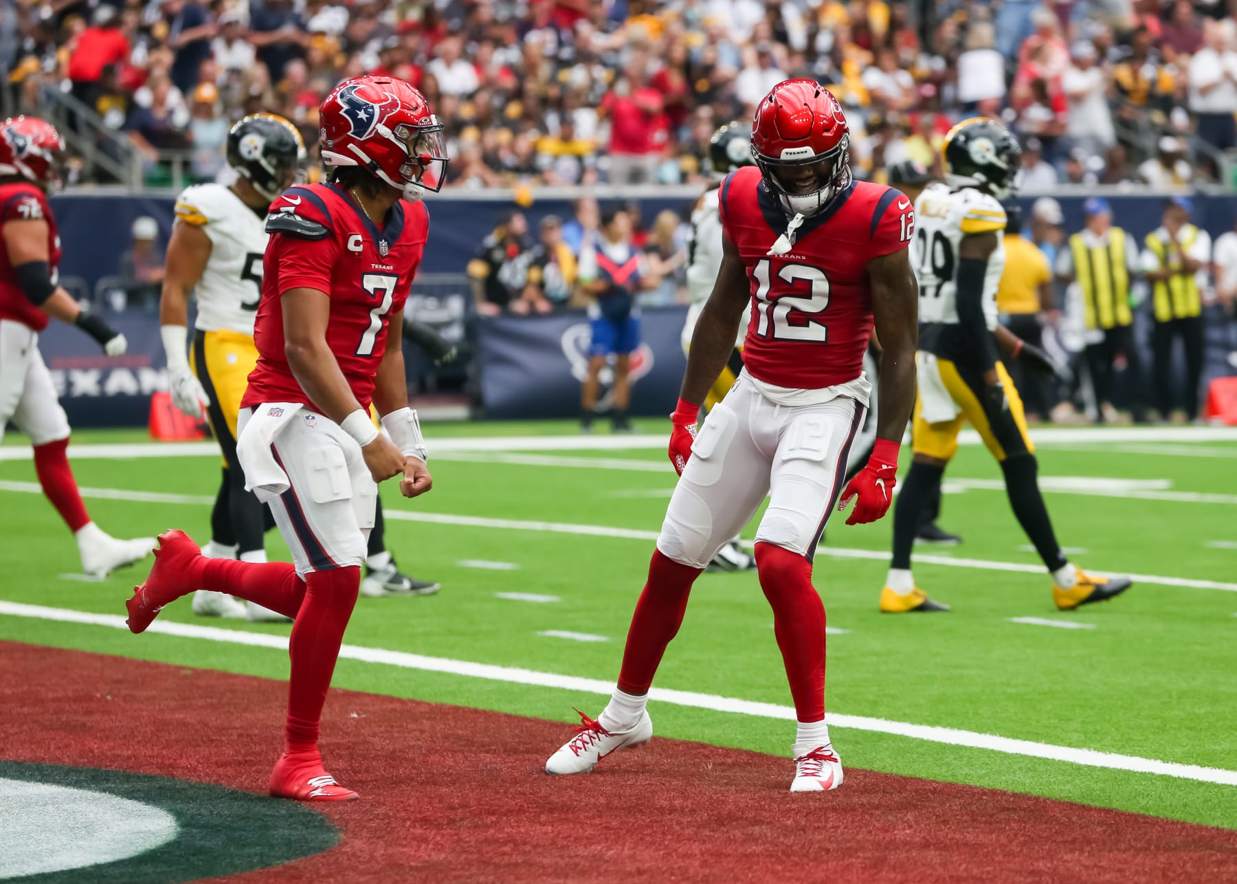 HOUSTON, TX - OCTOBER 01:  Houston Texans quarterback C.J. Stroud (7) celebrates Houston Texans wide receiver Nico Collins (12) touchdown in the first quarter during the NFL game between the Pittsburgh Steelers and Houston Texans on October 1, 2023 at NRG Stadium in Houston, Texas.  (Photo by Leslie Plaza Johnson/Icon Sportswire via Getty Images)