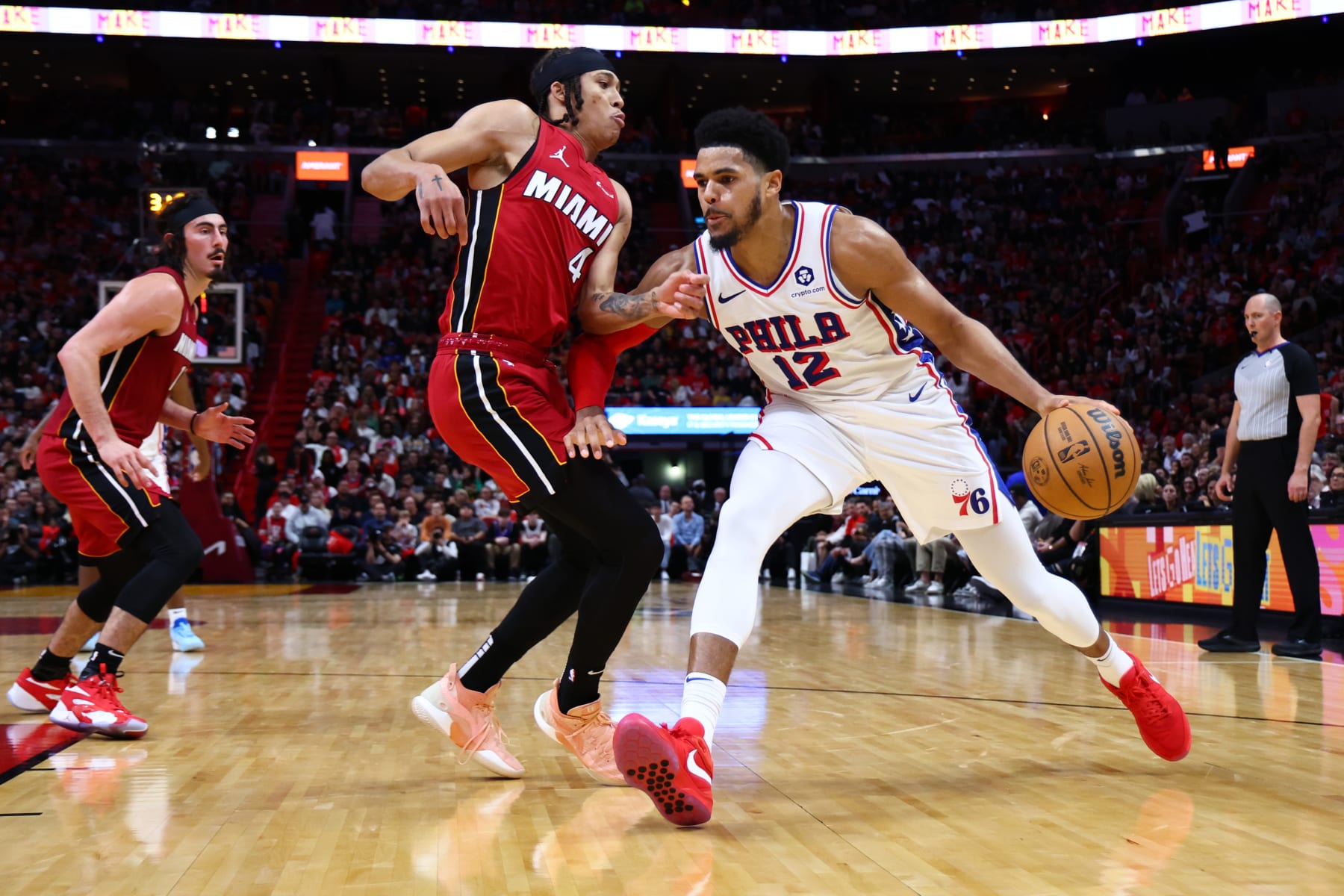 MIAMI, FLORIDA - DECEMBER 25: Tobias Harris #12 of the Philadelphia 76ers drives against R.J. Hampton #4 of the Miami Heat during the second quarter of the game at Kaseya Center on December 25, 2023 in Miami, Florida. NOTE TO USER: User expressly acknowledges and agrees that, by downloading and or using this photograph, User is consenting to the terms and conditions of the Getty Images License Agreement. (Photo by Megan Briggs/Getty Images)
