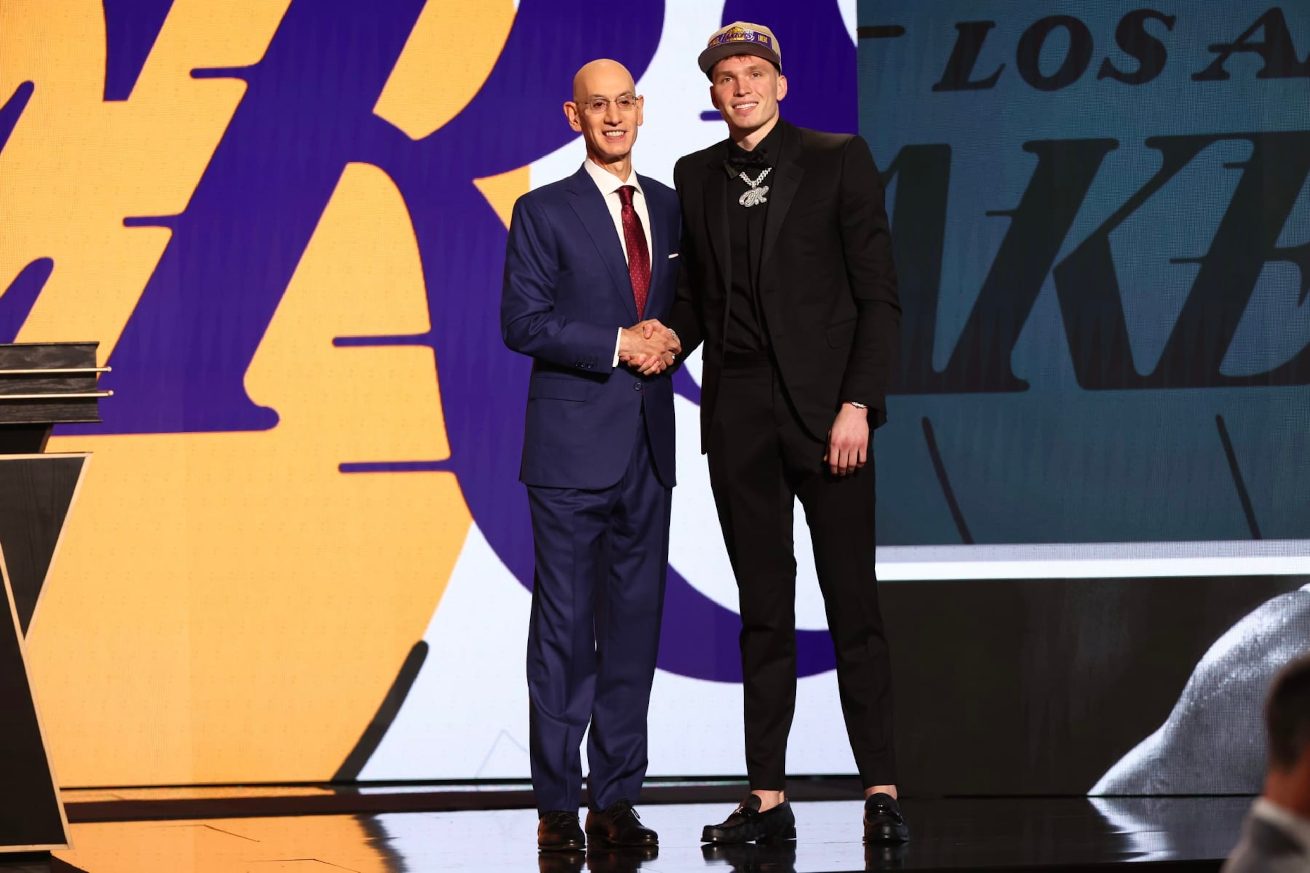 NEW YORK, NEW YORK - JUNE 26: Dalton Knecht (R) shakes hands with NBA commissioner Adam Silver (L) after being drafted 17th overall by the Los Angeles Lakers during the first round of the 2024 NBA Draft at Barclays Center on June 26, 2024 in the Brooklyn borough of New York City. NOTE TO USER: User expressly acknowledges and agrees that, by downloading and or using this photograph, User is consenting to the terms and conditions of the Getty Images License Agreement. (Photo by Sarah Stier/Getty Images)