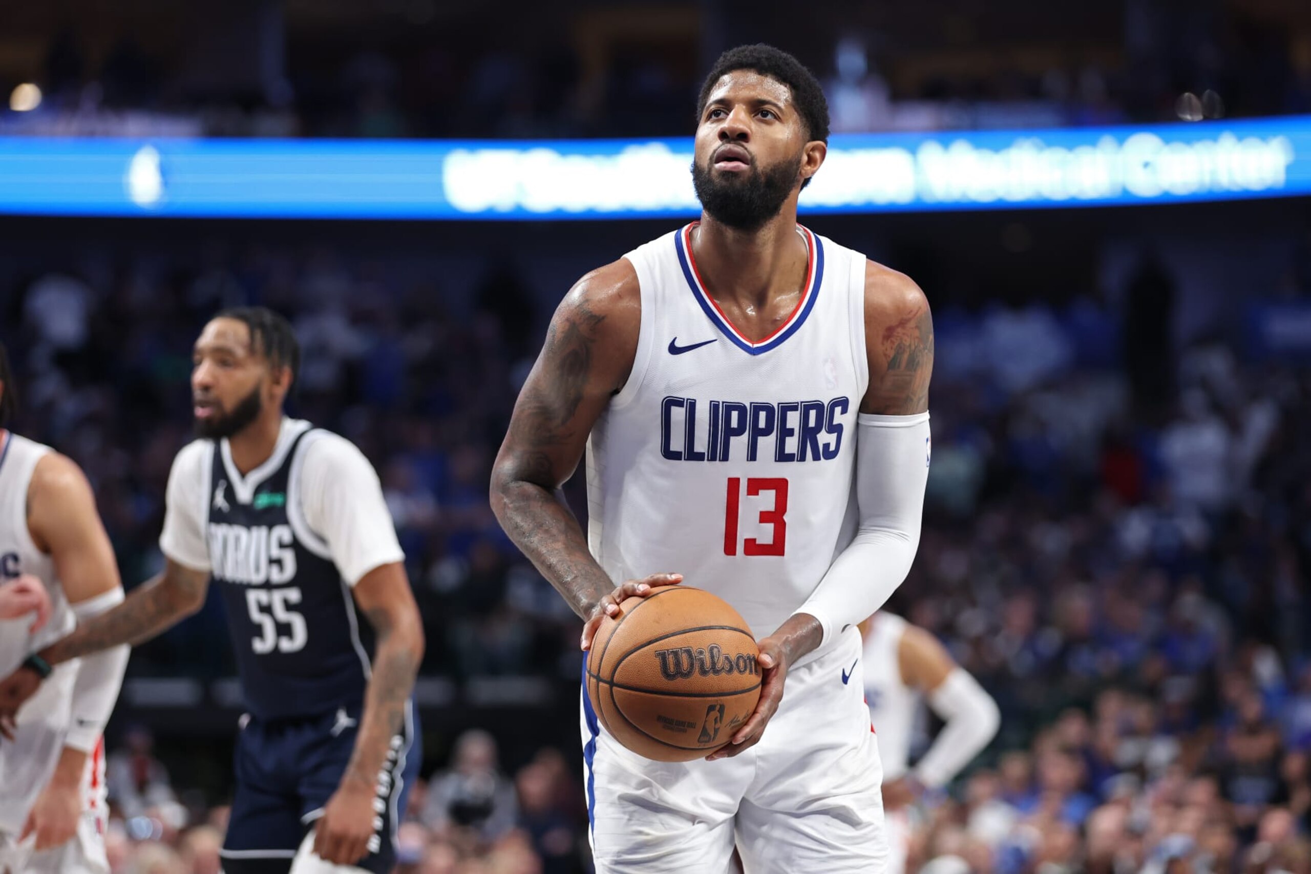 DALLAS, TX - APRIL 28: Paul George #13 of the LA Clippers shoots a free throw during the game against the Dallas Mavericks during Round 1 Game 4 of the 2024 NBA Playoffs on April 28, 2024 at the American Airlines Center in Dallas, Texas. NOTE TO USER: User expressly acknowledges and agrees that, by downloading and or using this photograph, User is consenting to the terms and conditions of the Getty Images License Agreement. Mandatory Copyright Notice: Copyright 2024 NBAE (Photo by Tim Heitman/NBAE via Getty Images)