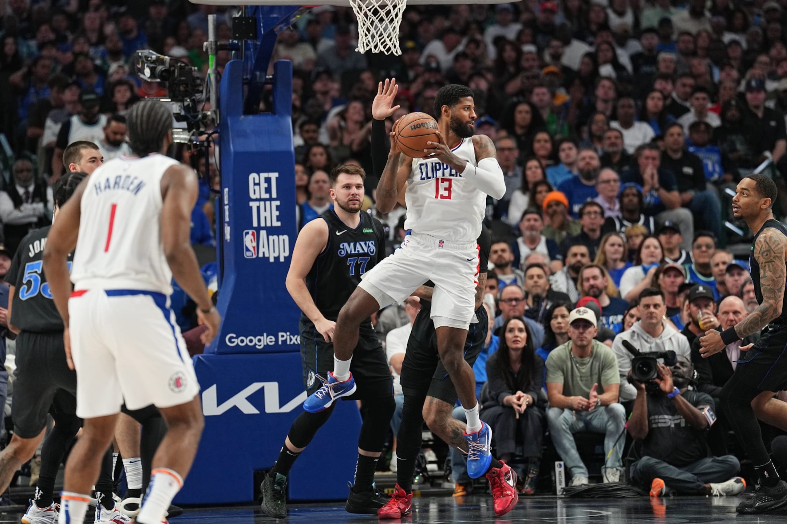 DALLAS, TX - MAY 3: Paul George #13 of the LA Clippers grabs a rebound during the game against the Dallas Mavericks during Round 1 Game 6 of the 2024 NBA Playoffs  on May 3, 2024  at the American Airlines Center in Dallas, Texas. NOTE TO USER: User expressly acknowledges and agrees that, by downloading and or using this photograph, User is consenting to the terms and conditions of the Getty Images License Agreement. Mandatory Copyright Notice: Copyright 2024 NBAE (Photo by Glenn James/NBAE via Getty Images)