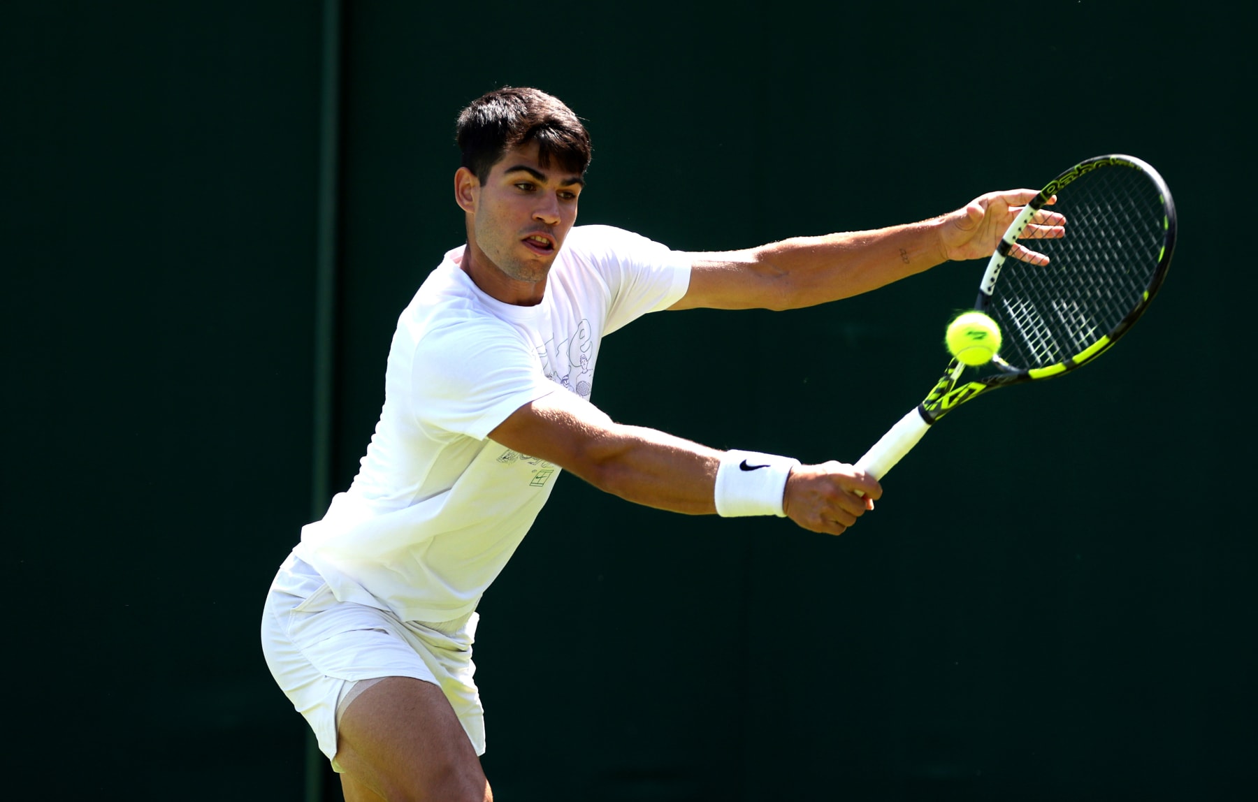 LONDON, ENGLAND - JUNE 29: Carlos Alcaraz of Spain plays a backhand during practice prior to The Championships Wimbledon 2024 at All England Lawn Tennis and Croquet Club on June 29, 2024 in London, England. (Photo by Clive Brunskill/Getty Images)