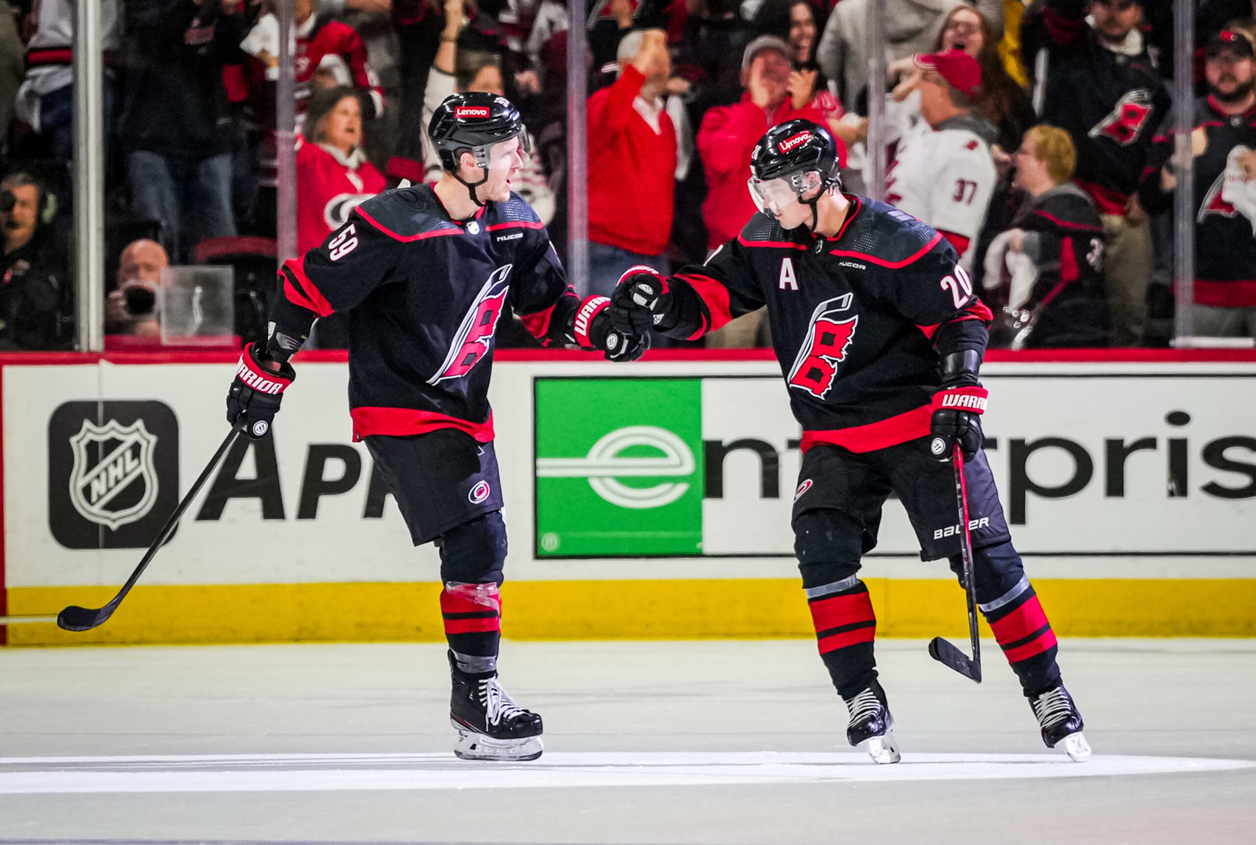 RALEIGH, NORTH CAROLINA - APRIL 22: Sebastian Aho #20 of the Carolina Hurricanes celebrates with Jake Guentzel #59 after a goal during the third period against the New York Islanders in Game Two of the First Round of the 2024 Stanley Cup Playoffs at PNC Arena on April 22, 2024 in Raleigh, North Carolina. (Photo by Josh Lavallee/NHLI via Getty Images)