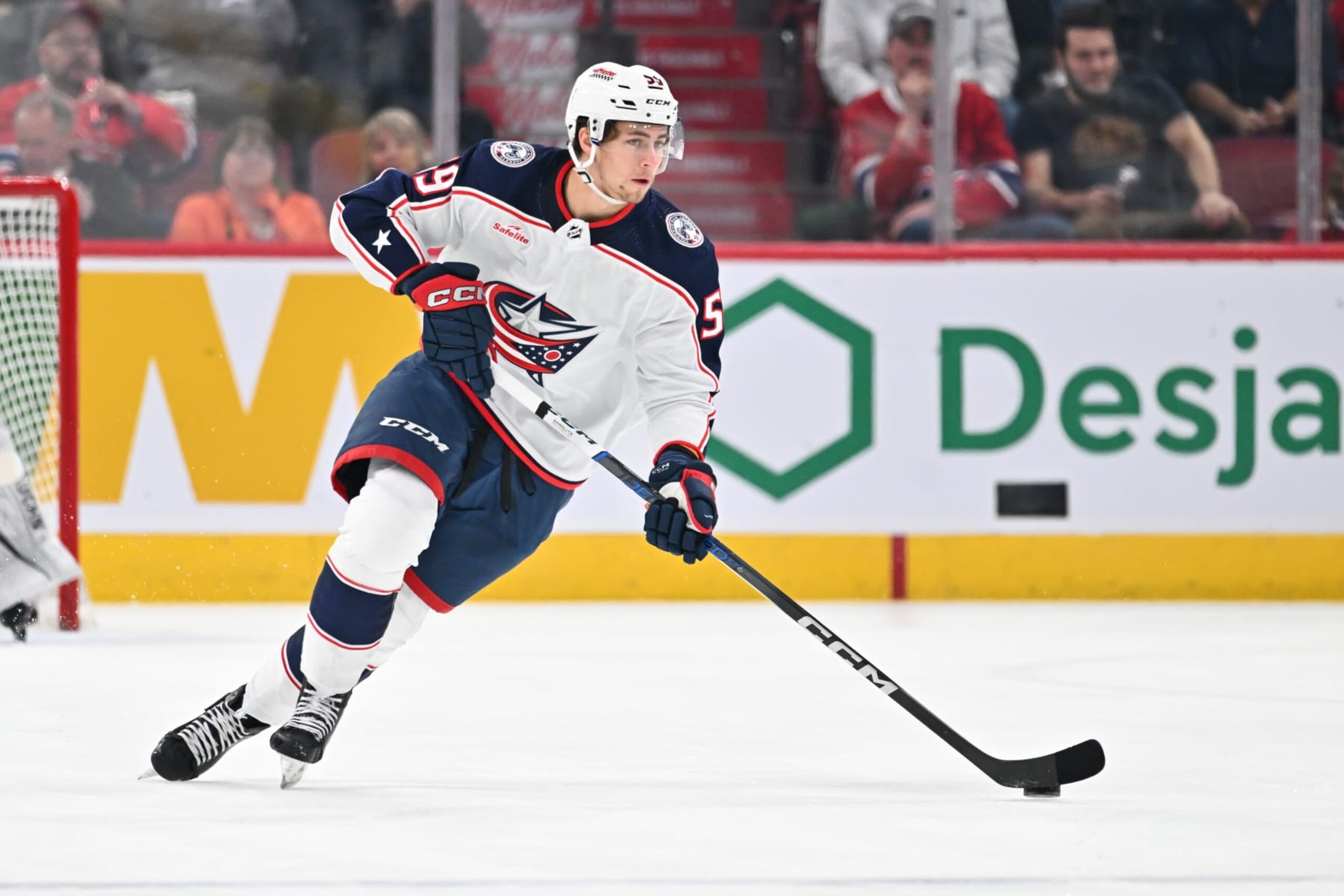 MONTREAL, CANADA - MARCH 12:  Yegor Chinakhov #59 of the Columbus Blue Jackets skates the puck during the first period against the Montreal Canadiens at the Bell Centre on March 12, 2024 in Montreal, Quebec, Canada.  The Montreal Canadiens defeated the Columbus Blue Jackets 3-0. (Photo by Minas Panagiotakis/Getty Images)